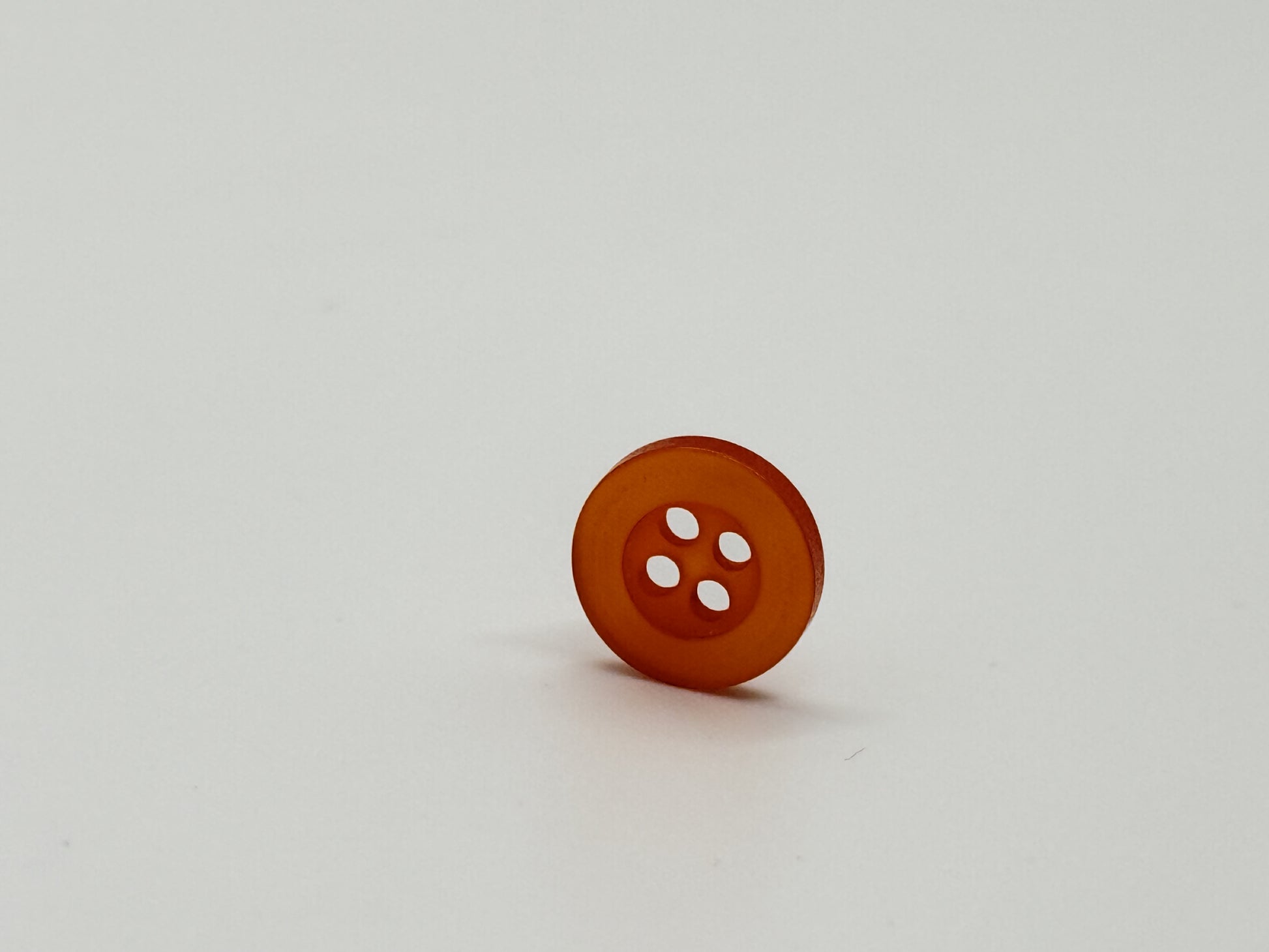 Close-up image of Orange Citrus Resin, a premium quality button.