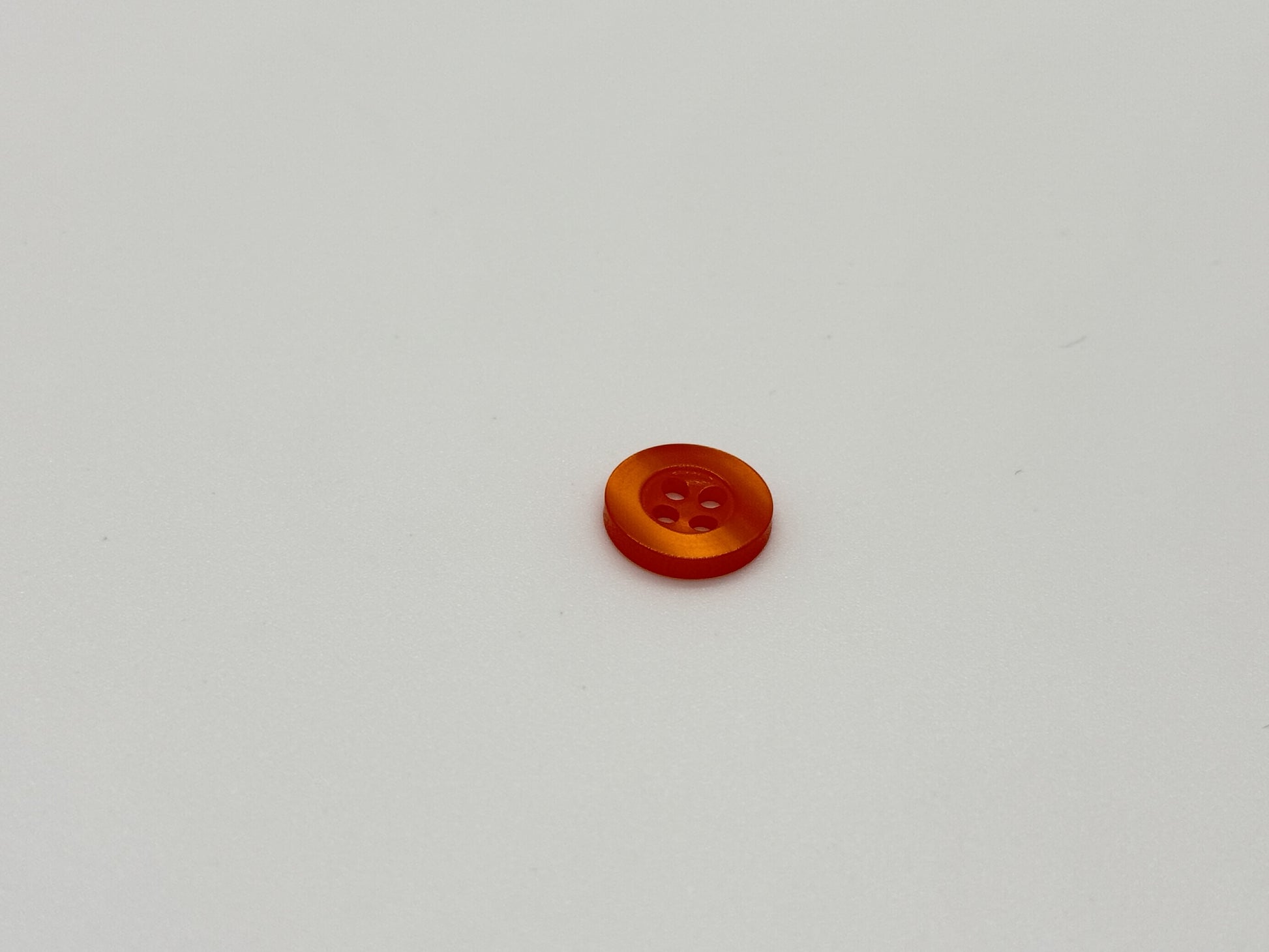 Close-up image of Orange Citrus Resin, a premium quality button.