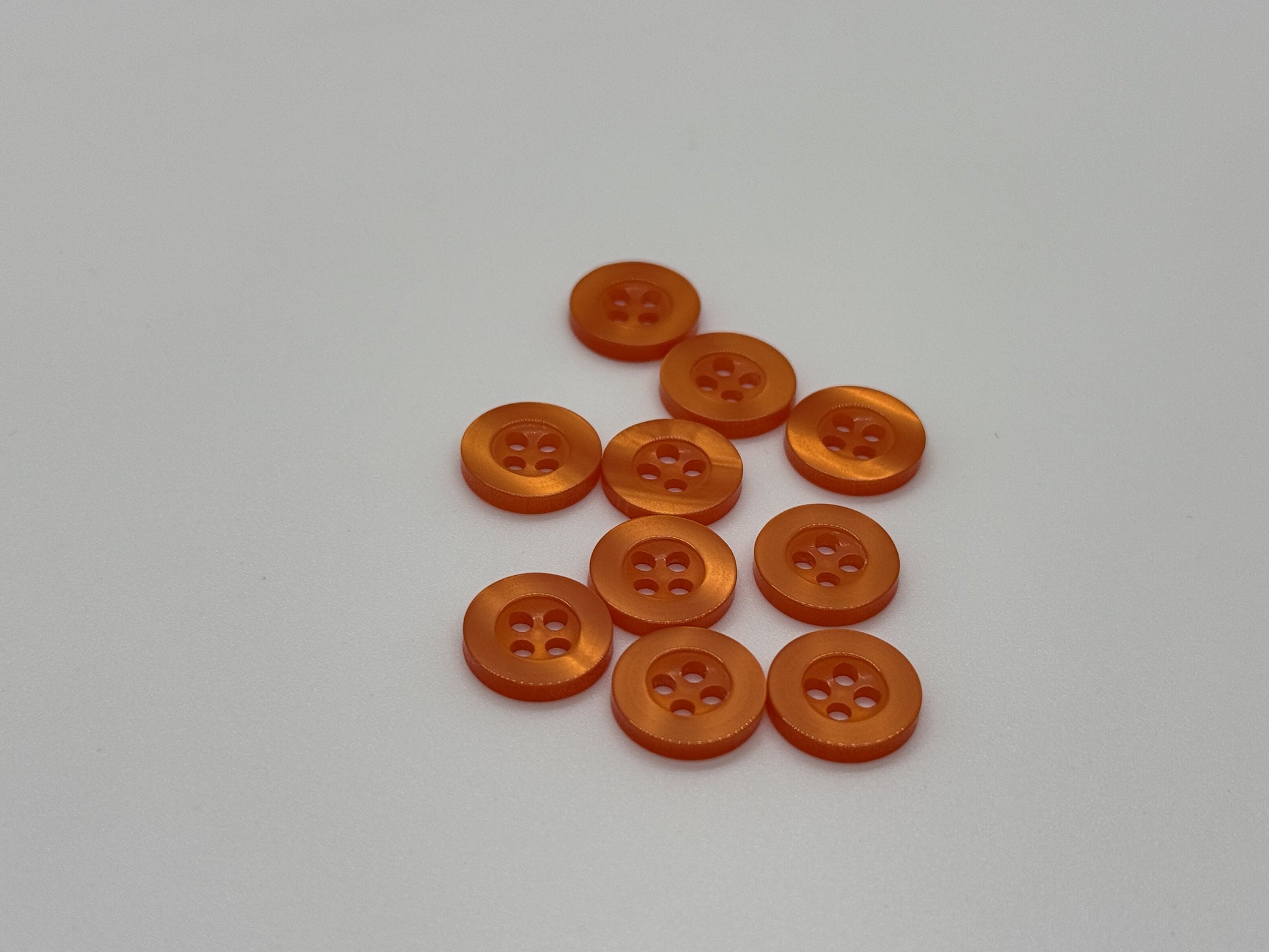 Close-up image of Orange Citrus Resin, a premium quality button.