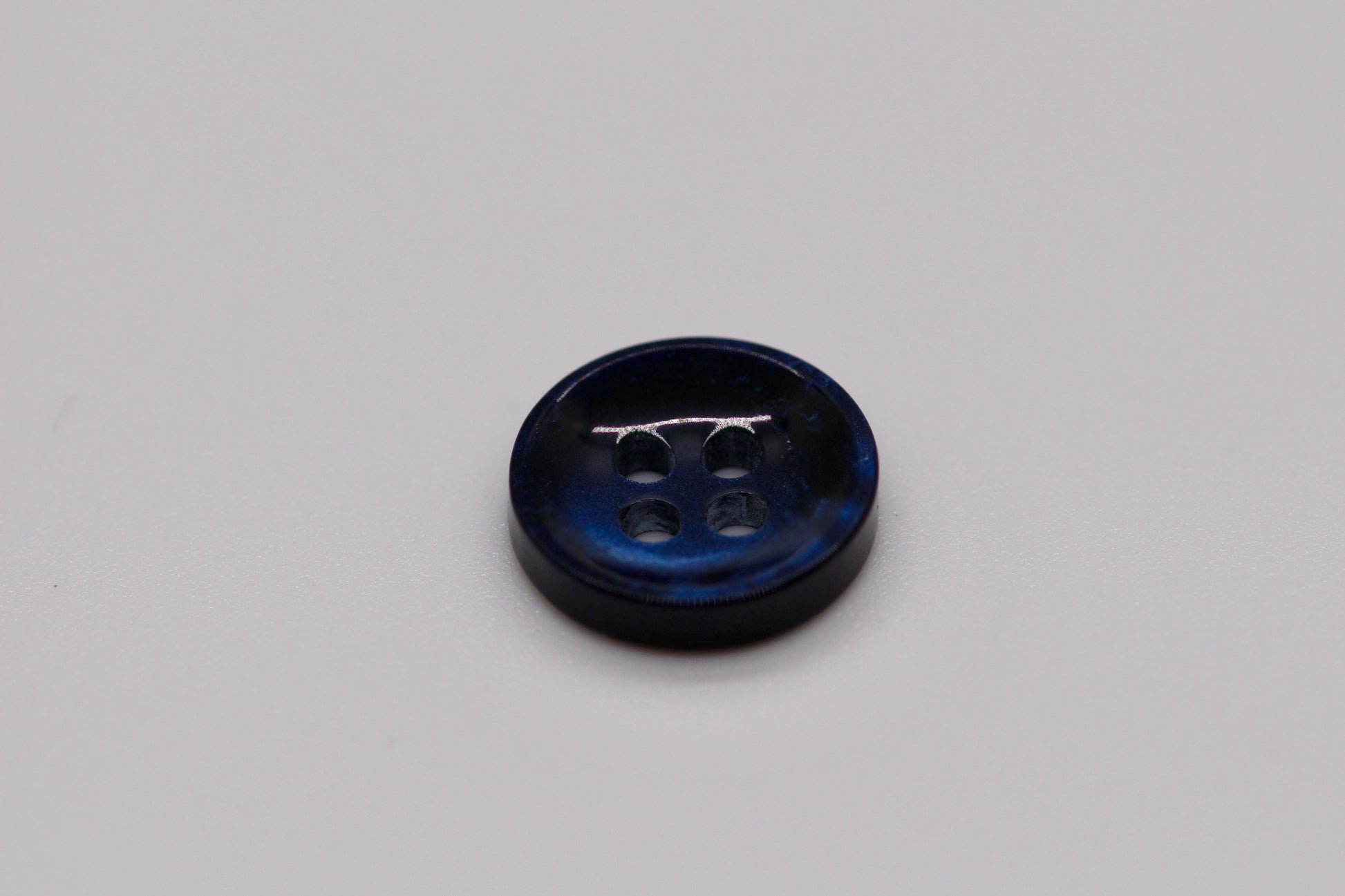 Close-up image of Pearl Blue Sunken Button, a premium quality button.