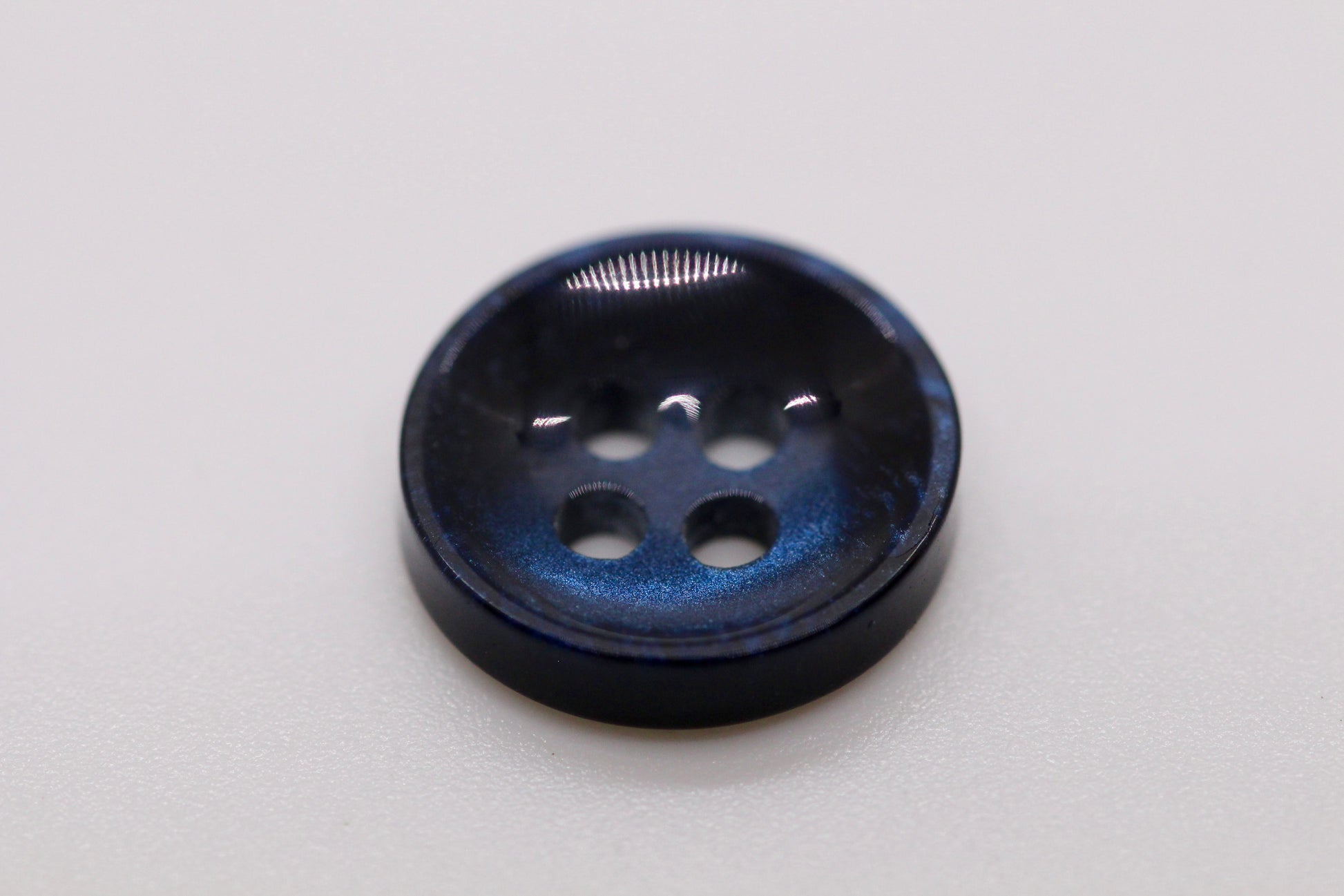 Close-up image of Pearl Blue Sunken Button, a premium quality button.