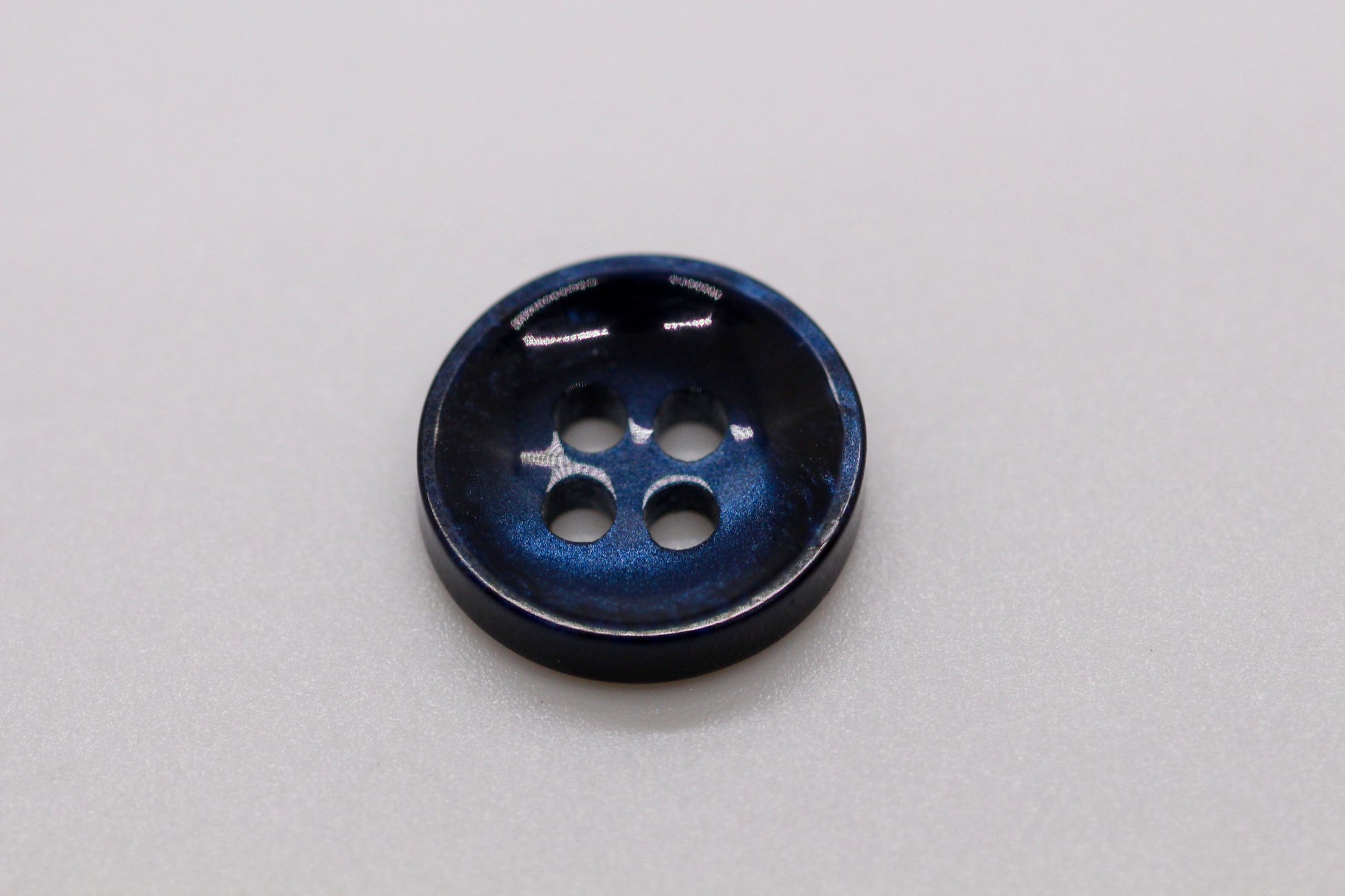 Close-up image of Pearl Blue Sunken Button, a premium quality button.