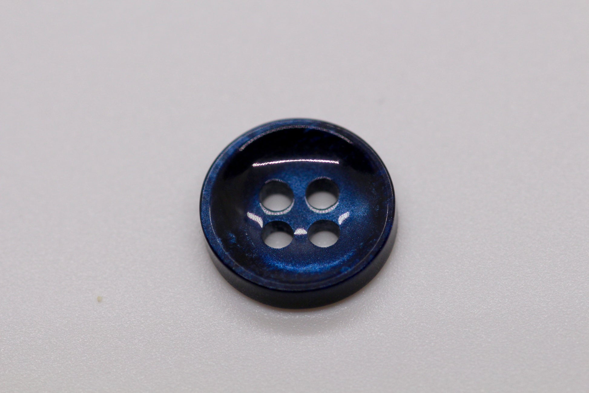 Close-up image of Pearl Blue Sunken Button, a premium quality button.