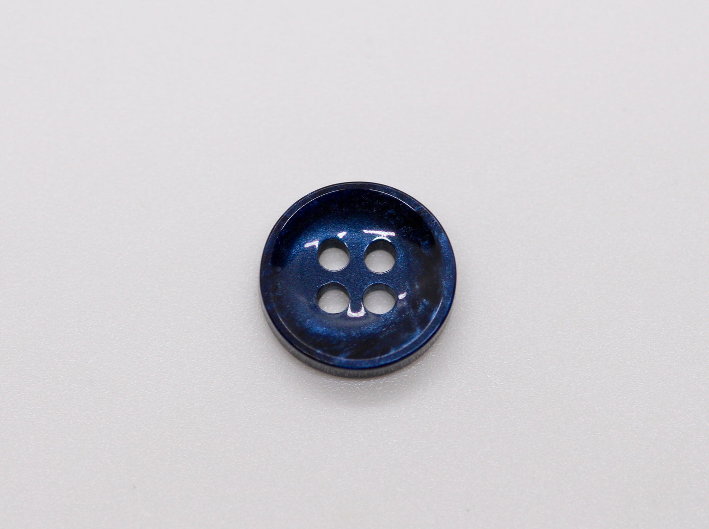 Close-up image of Pearl Blue Sunken Button, a premium quality button.