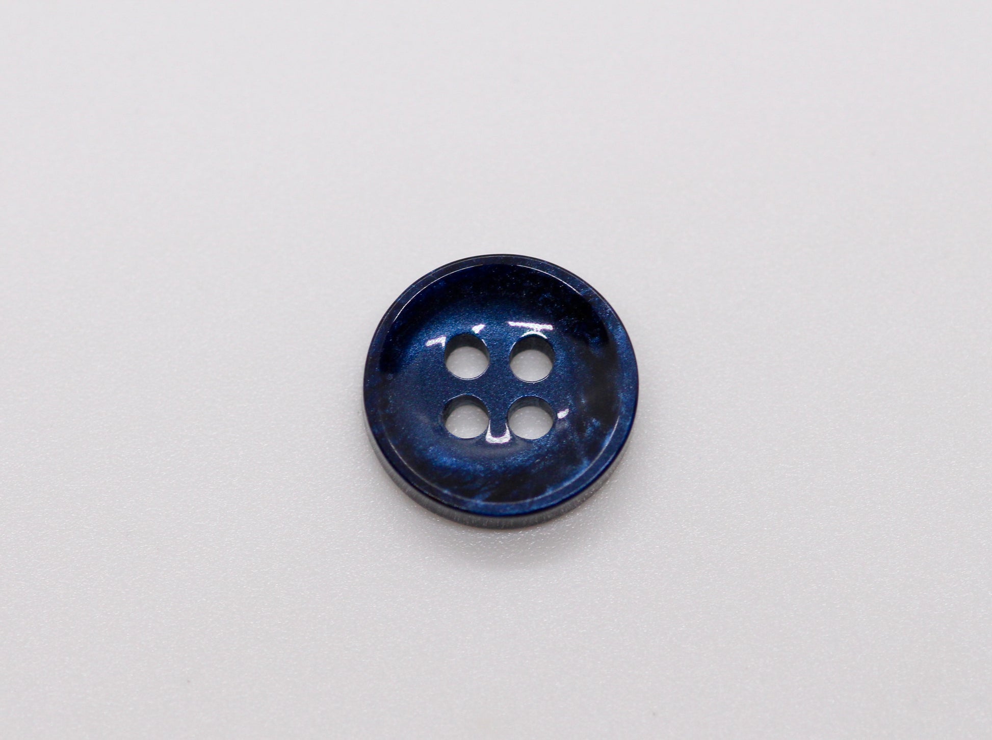 Close-up image of Pearl Blue Sunken Button, a premium quality button.