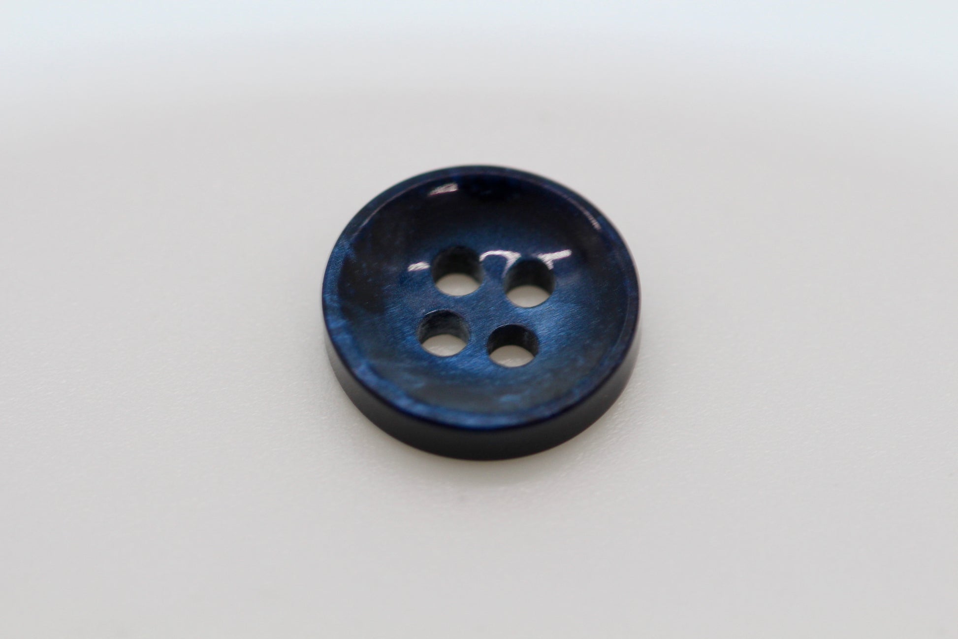 Close-up image of Pearl Blue Sunken Button, a premium quality button.