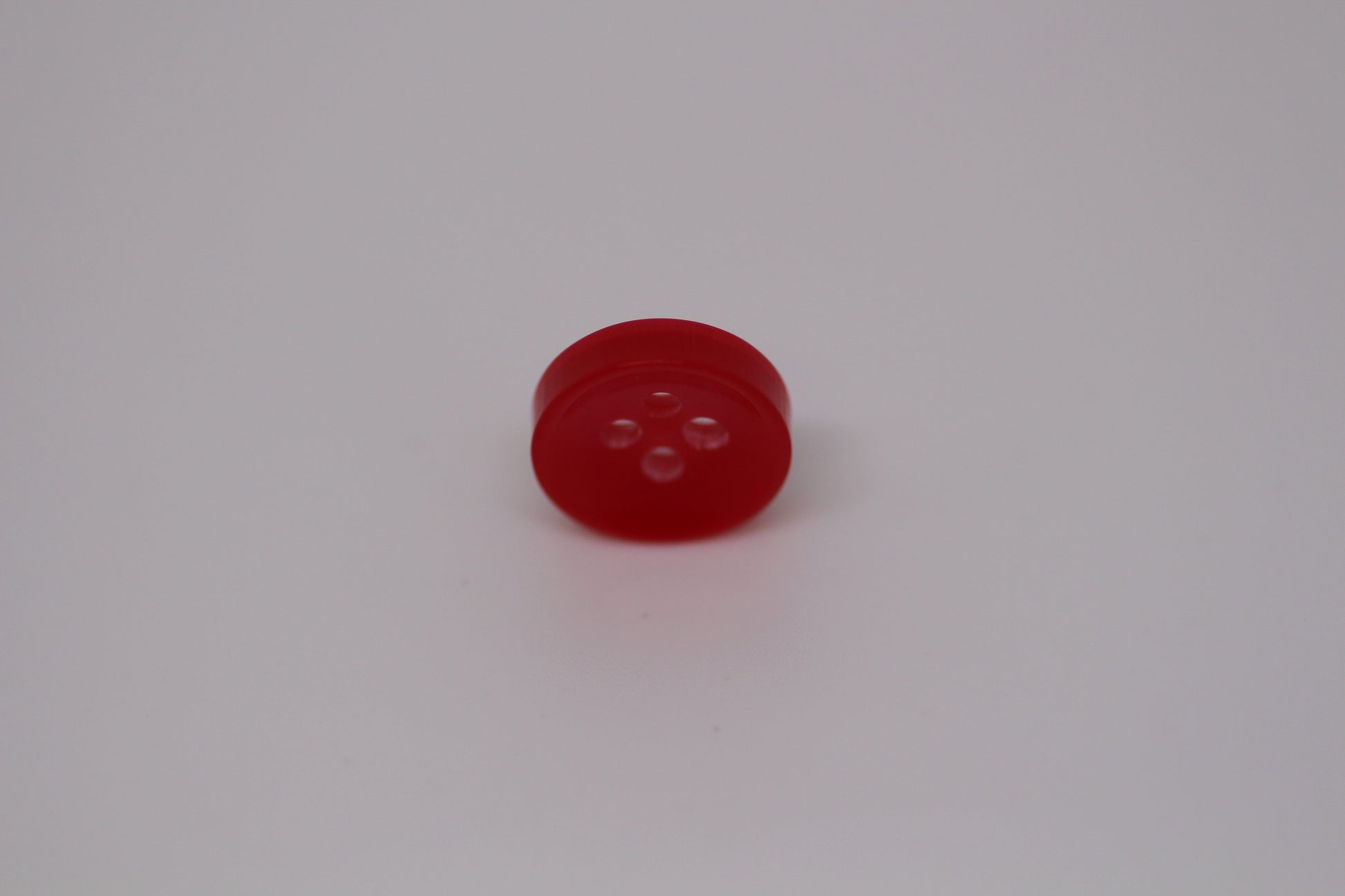 Close-up image of Red Sunken Button, a premium quality button.