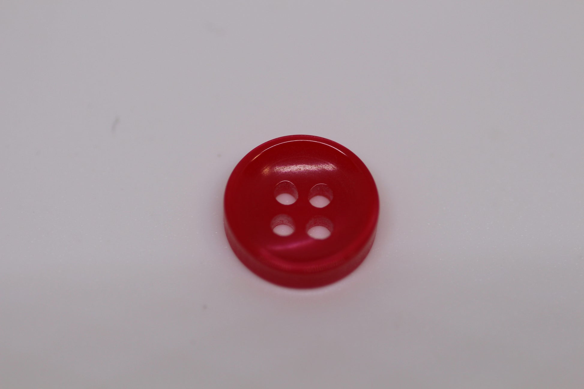 Close-up image of Red Sunken Button, a premium quality button.