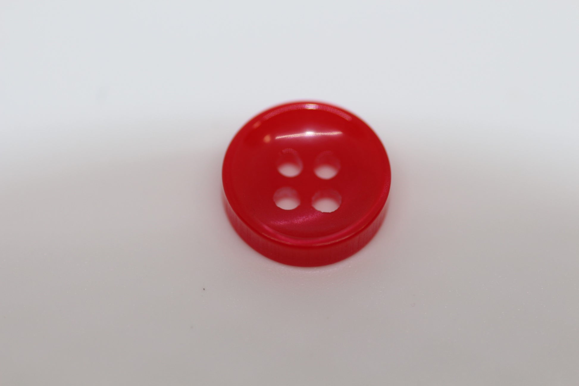 Close-up image of Red Sunken Button, a premium quality button.