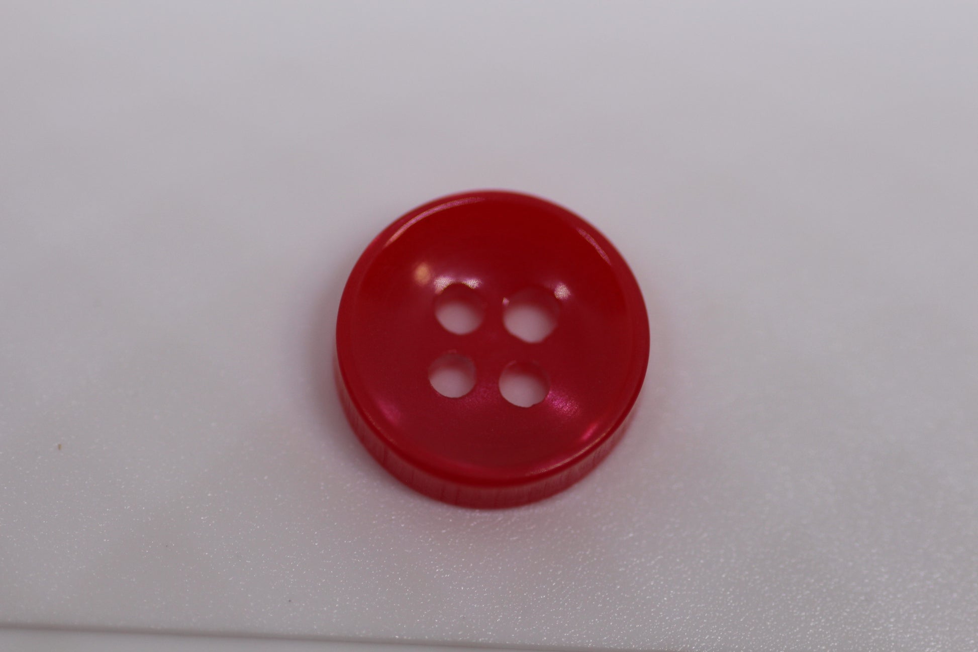 Close-up image of Red Sunken Button, a premium quality button.