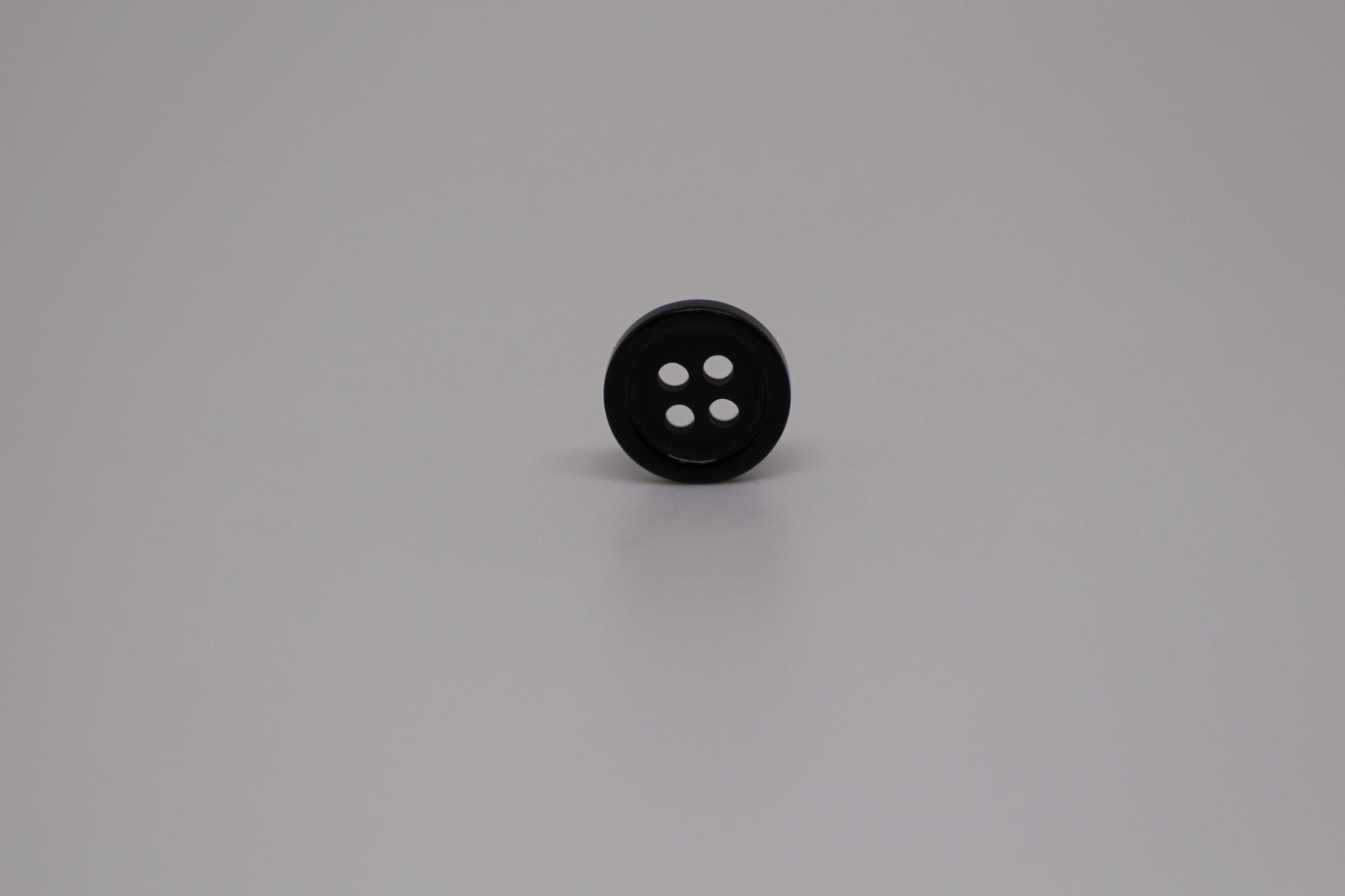 Close-up image of Black Pie Crust Polymer Button, a premium quality button.
