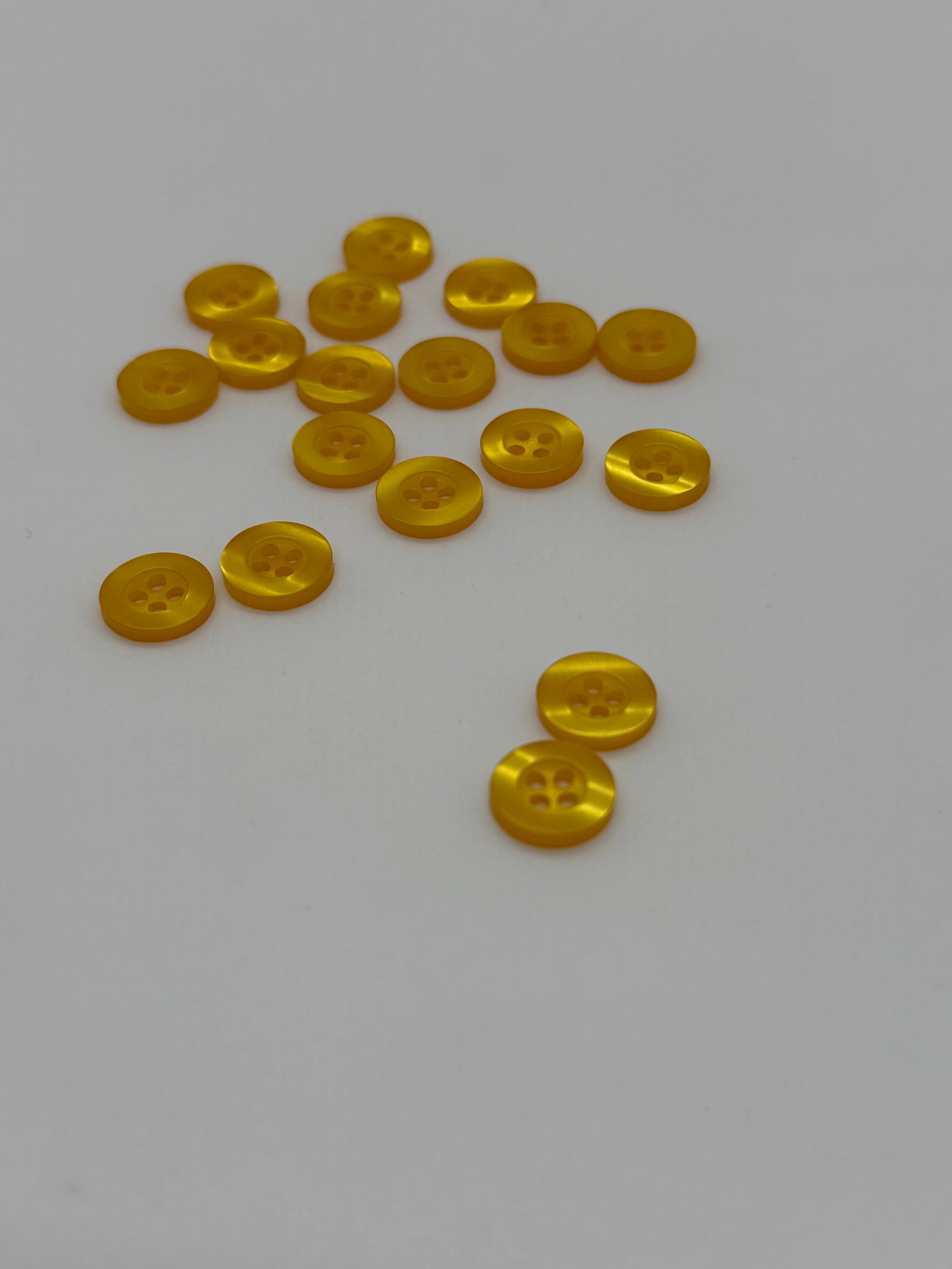 Close-up image of Fancy Amber Resin 4-Hole Button, a premium quality button.