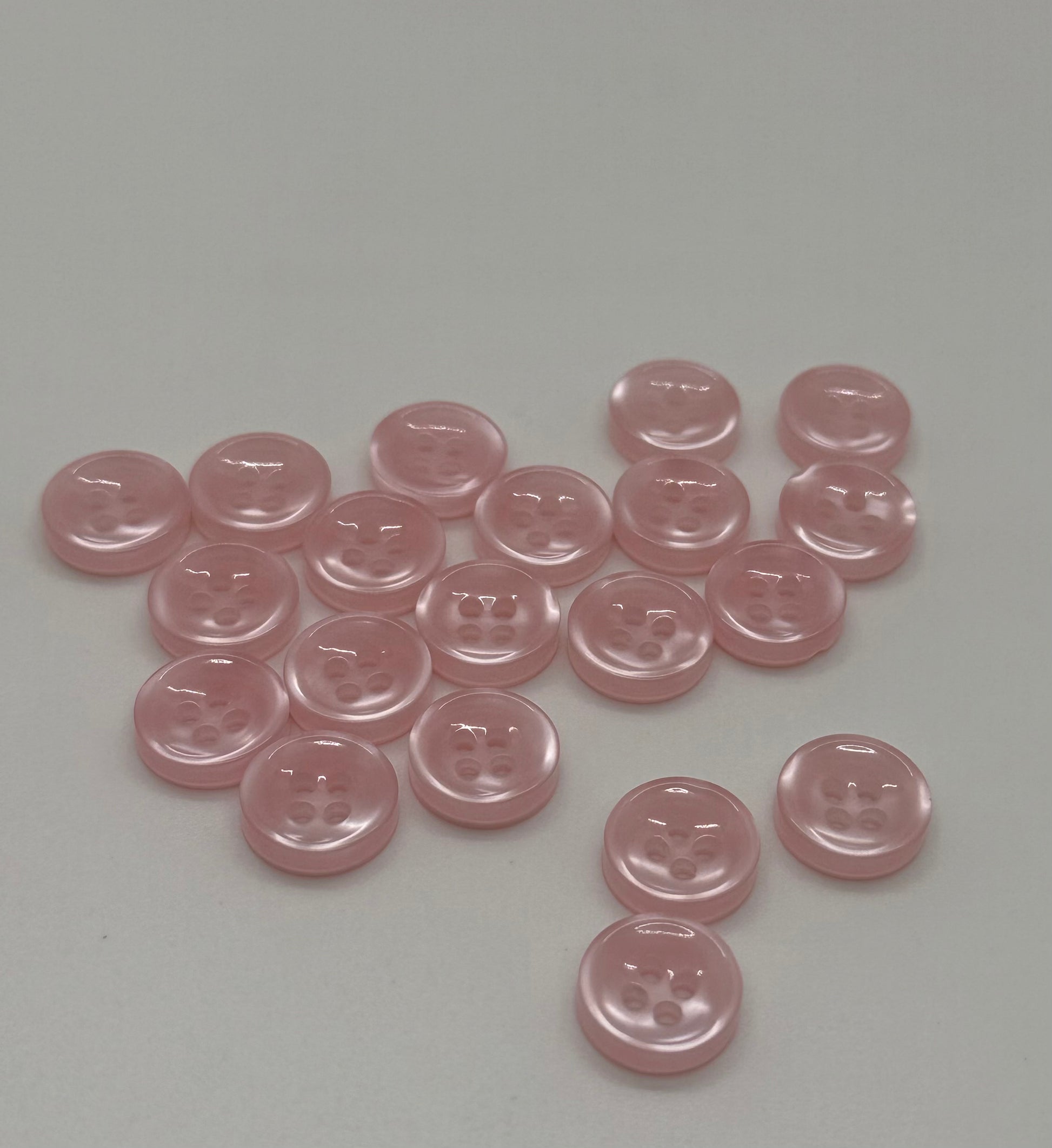 Close-up image of Blush Beam - Light Pink Iridescent 18-Ligne Button, a premium quality button.
