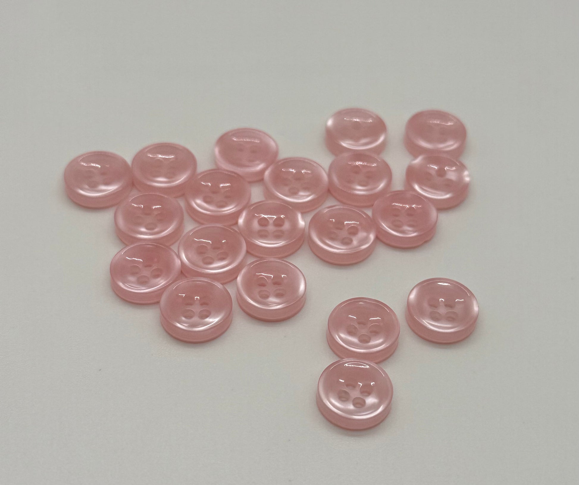 Close-up image of Blush Beam - Light Pink Iridescent 18-Ligne Button, a premium quality button.