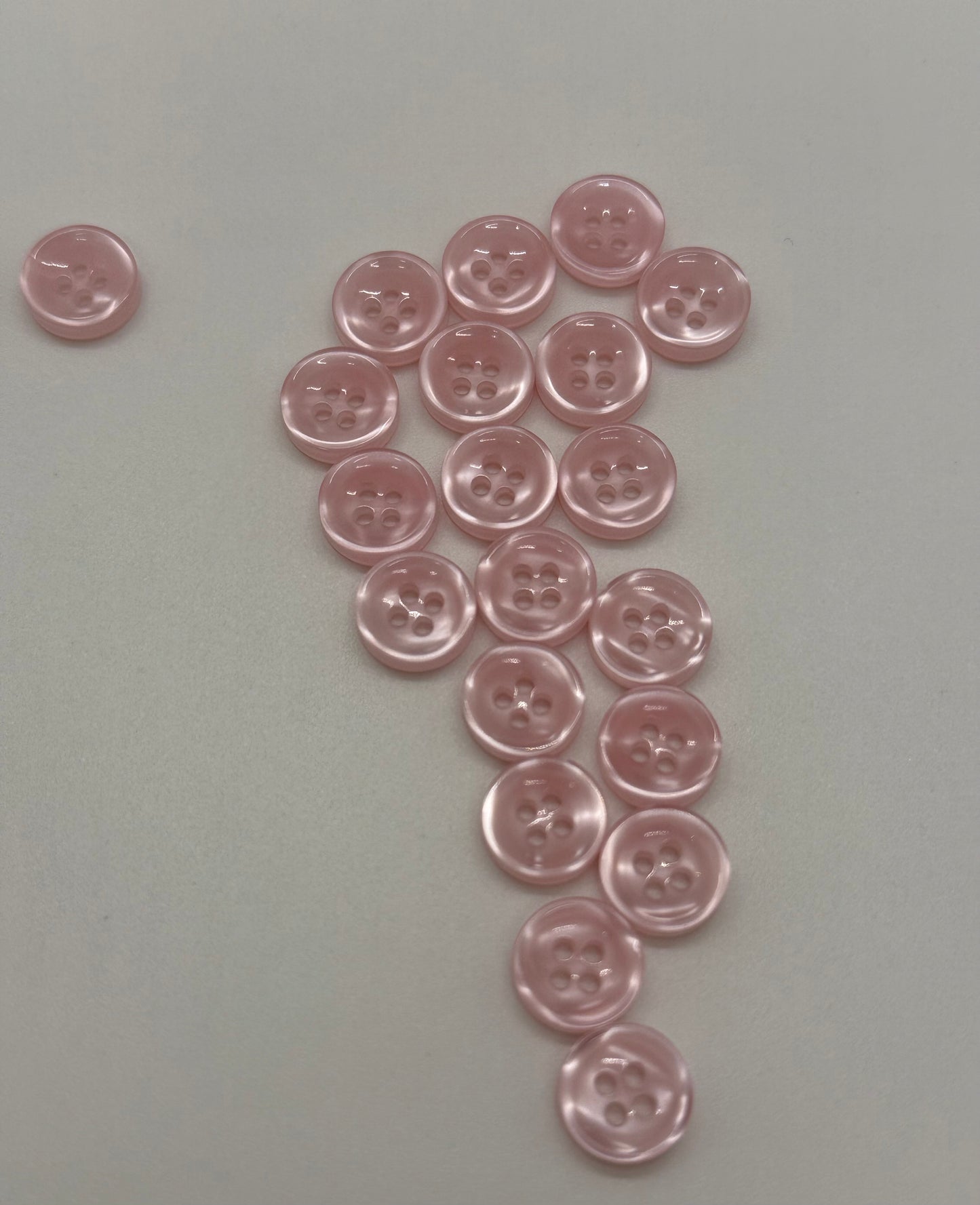 Close-up image of Blush Beam - Light Pink Iridescent 18-Ligne Button, a premium quality button.