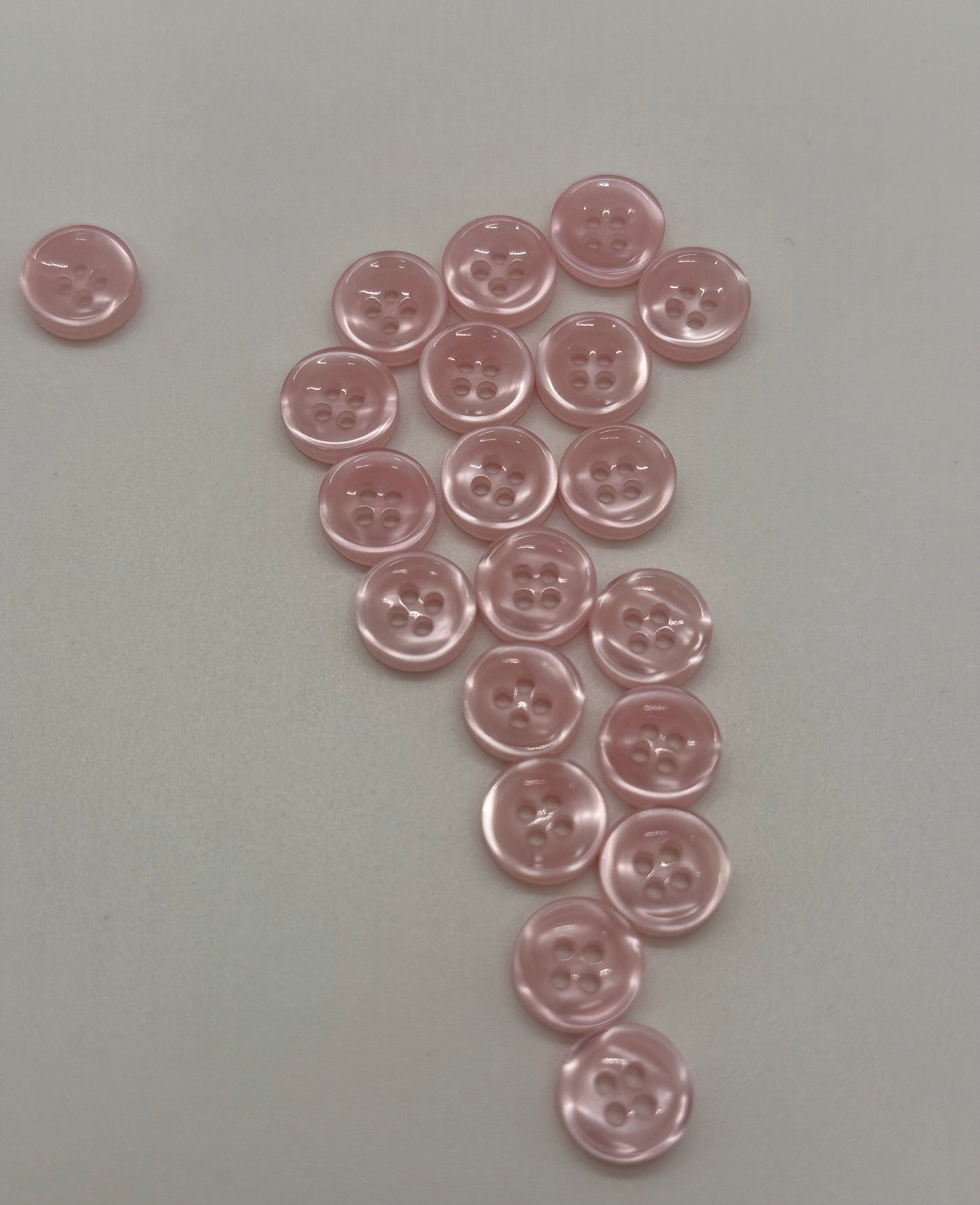 Close-up image of Blush Beam - Light Pink Iridescent 18-Ligne Button, a premium quality button.
