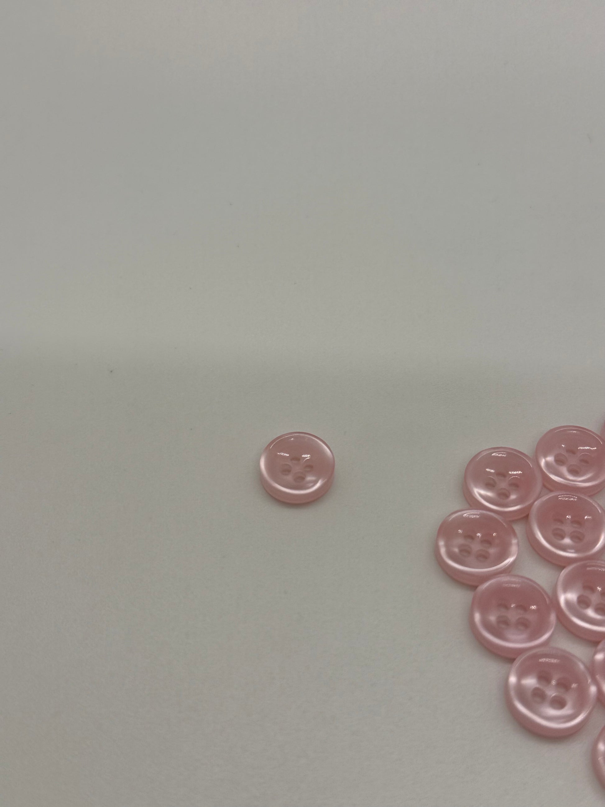 Close-up image of Blush Beam - Light Pink Iridescent 18-Ligne Button, a premium quality button.