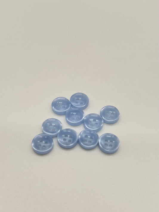 Close-up image of Crystal Tide - Light Blue Iridescent 18-Ligne Button, a premium quality button.