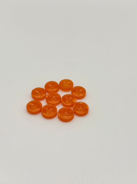 Close-up image of Ember Glow - Orange Iridescent 18-Ligne Button, a premium quality button.