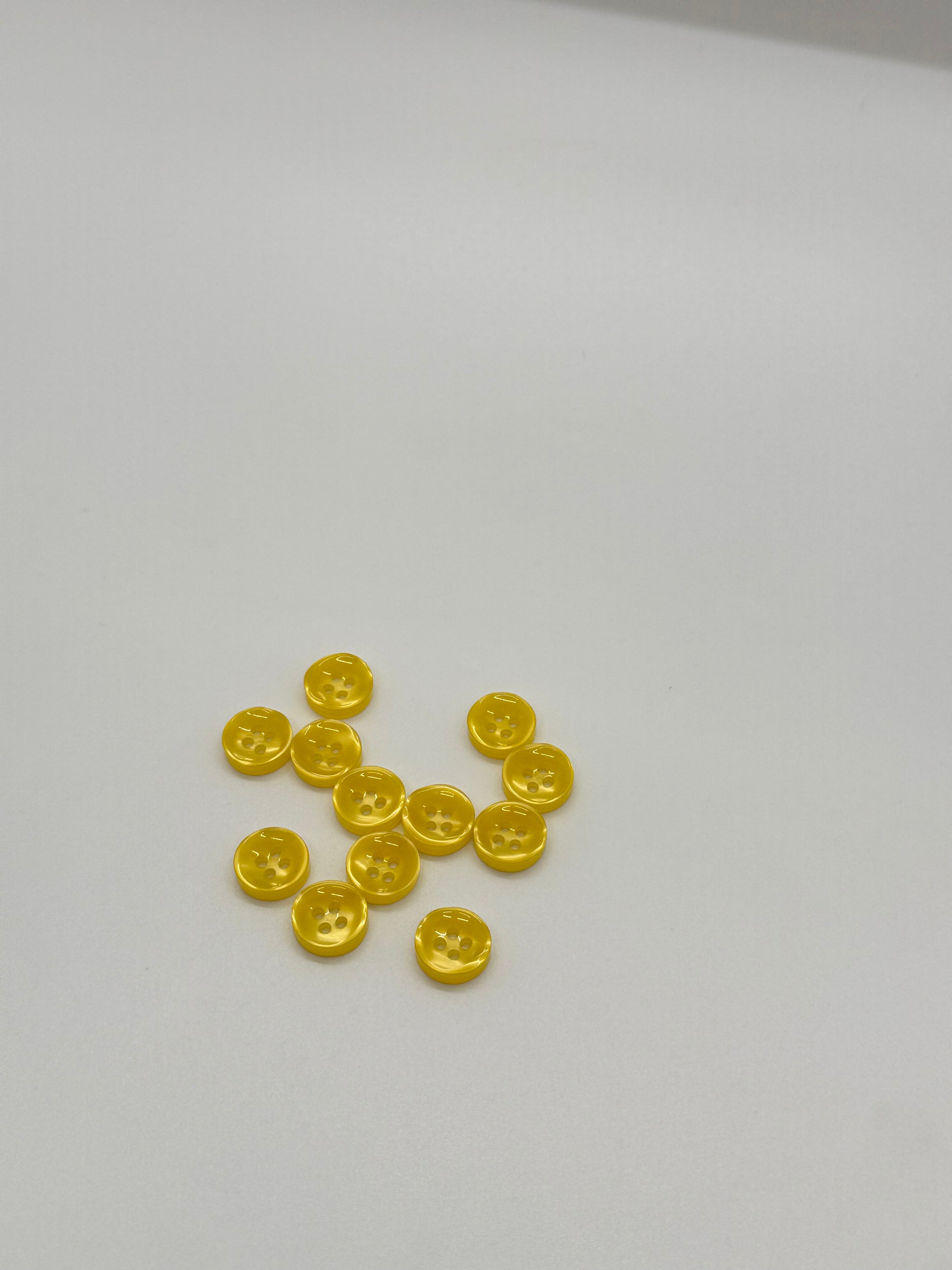 Close-up image of Golden Hour - Yellow Iridescent 18-Ligne Button, a premium quality button.