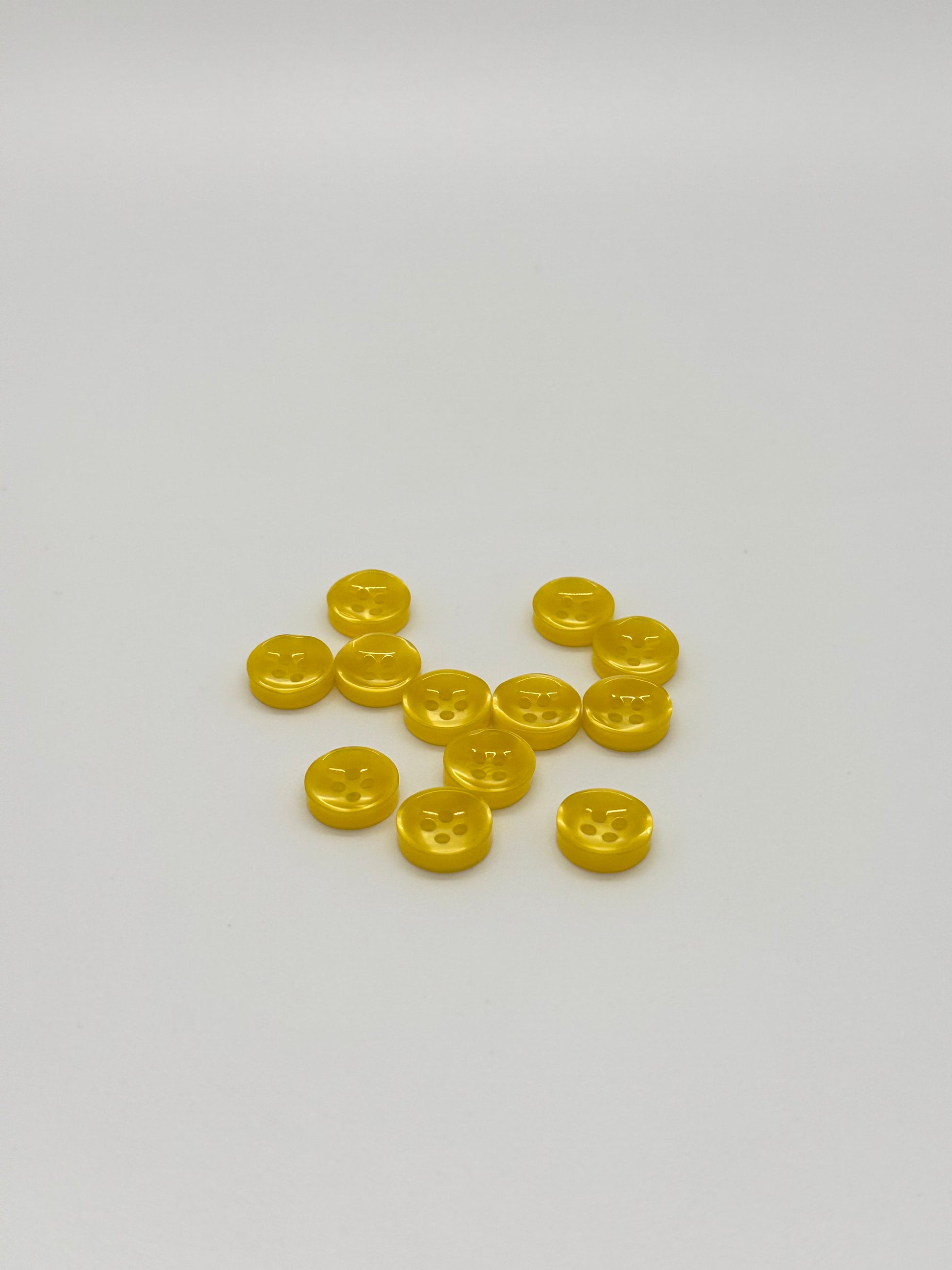Close-up image of Golden Hour - Yellow Iridescent 18-Ligne Button, a premium quality button.