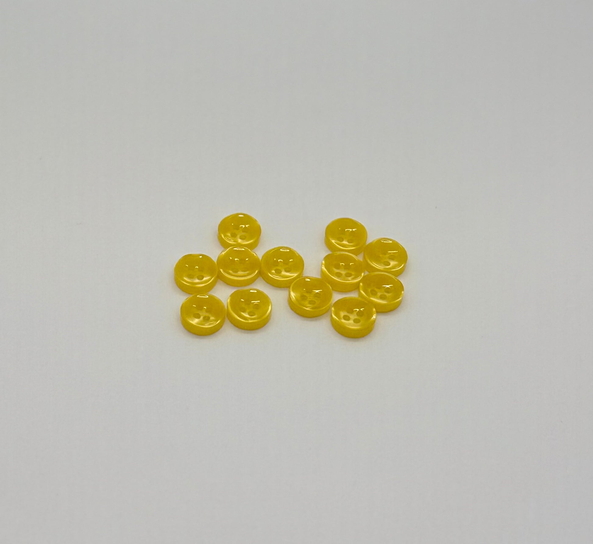 Close-up image of Golden Hour - Yellow Iridescent 18-Ligne Button, a premium quality button.