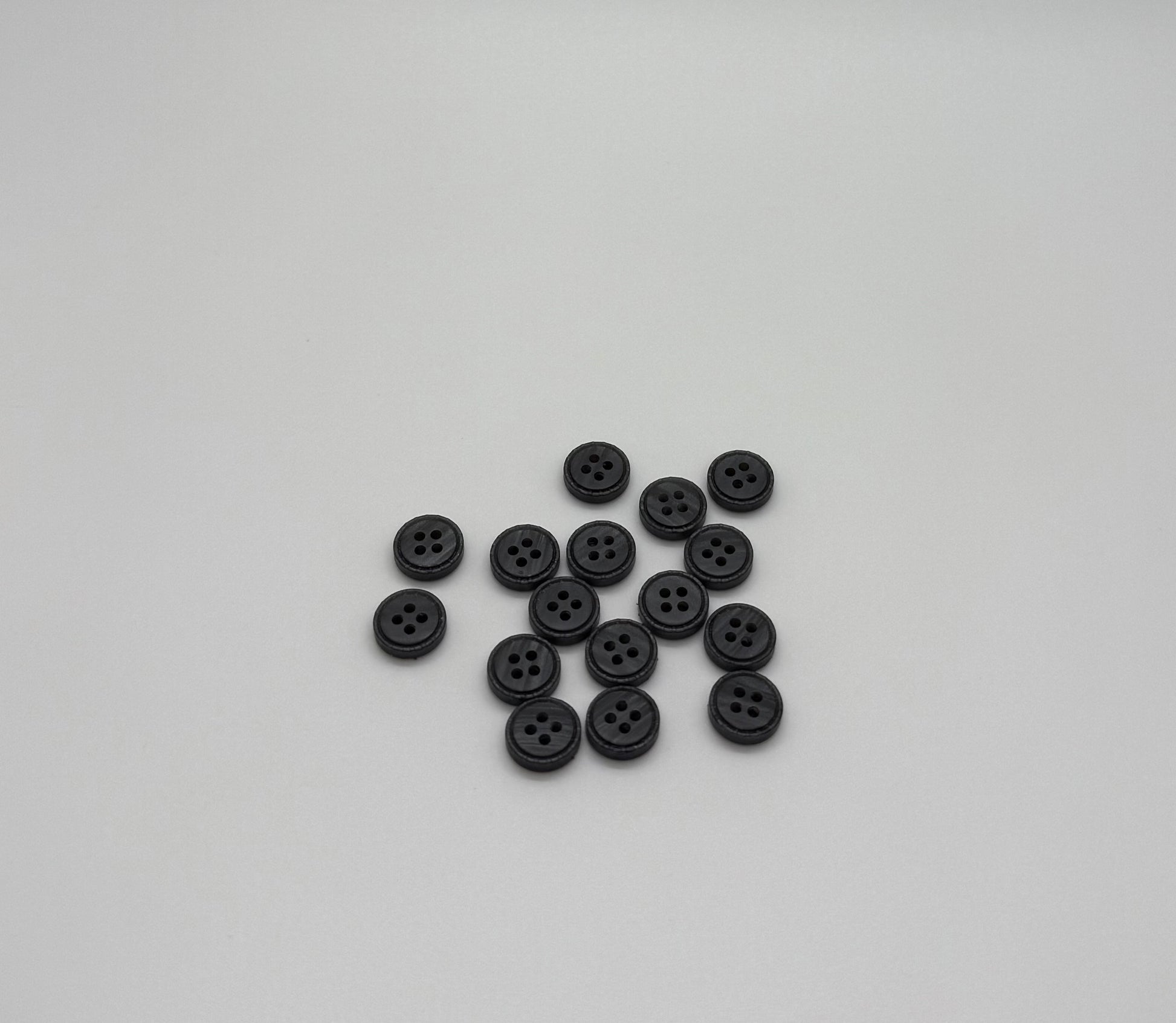 Close-up image of Iron Crest Rustic Grey - Engraved Edge Button, a premium quality button.