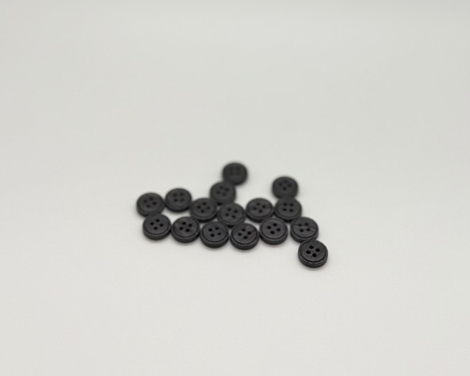 Close-up image of Iron Crest Rustic Grey - Engraved Edge Button, a premium quality button.