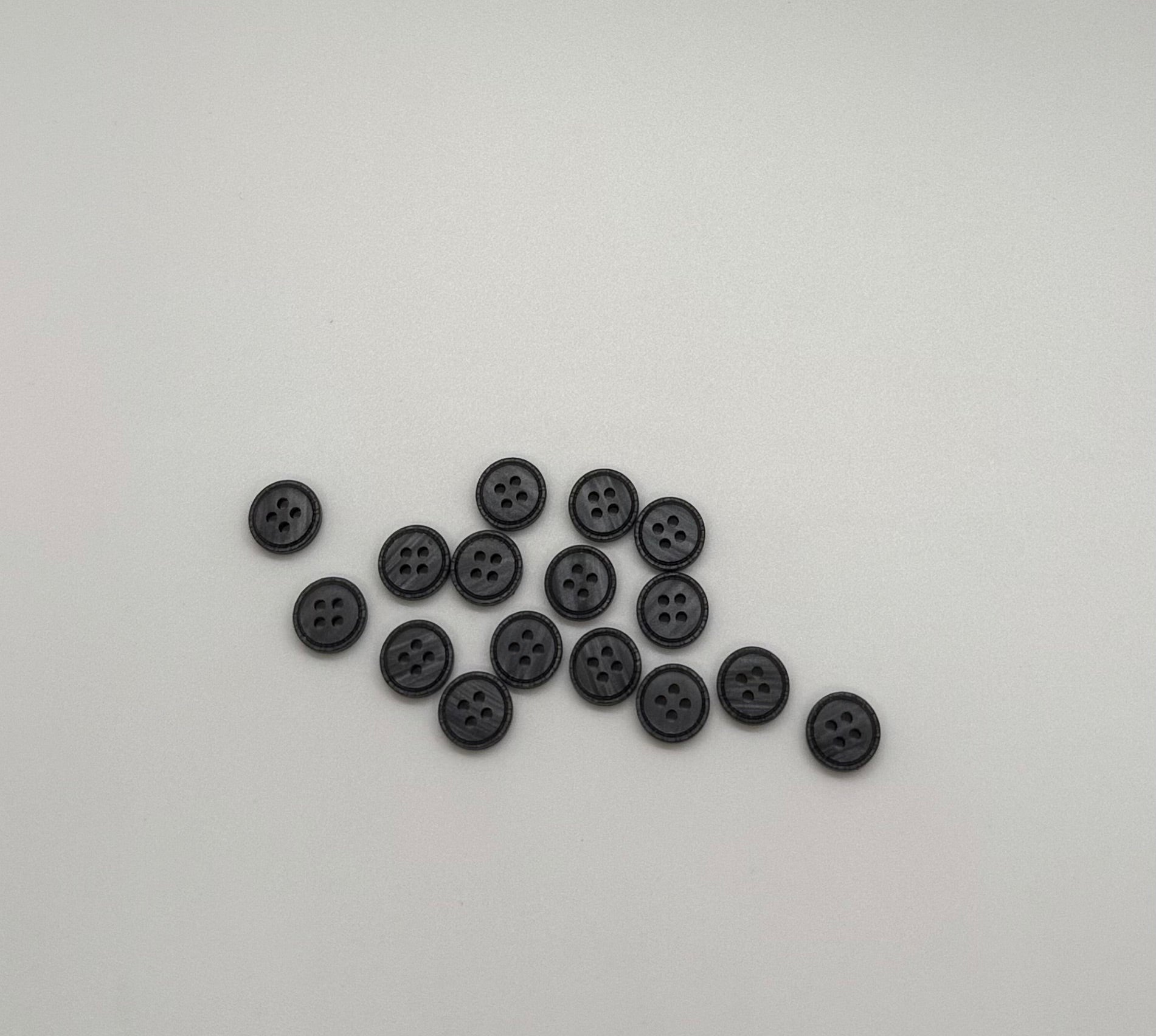 Close-up image of Iron Crest Rustic Grey - Engraved Edge Button, a premium quality button.