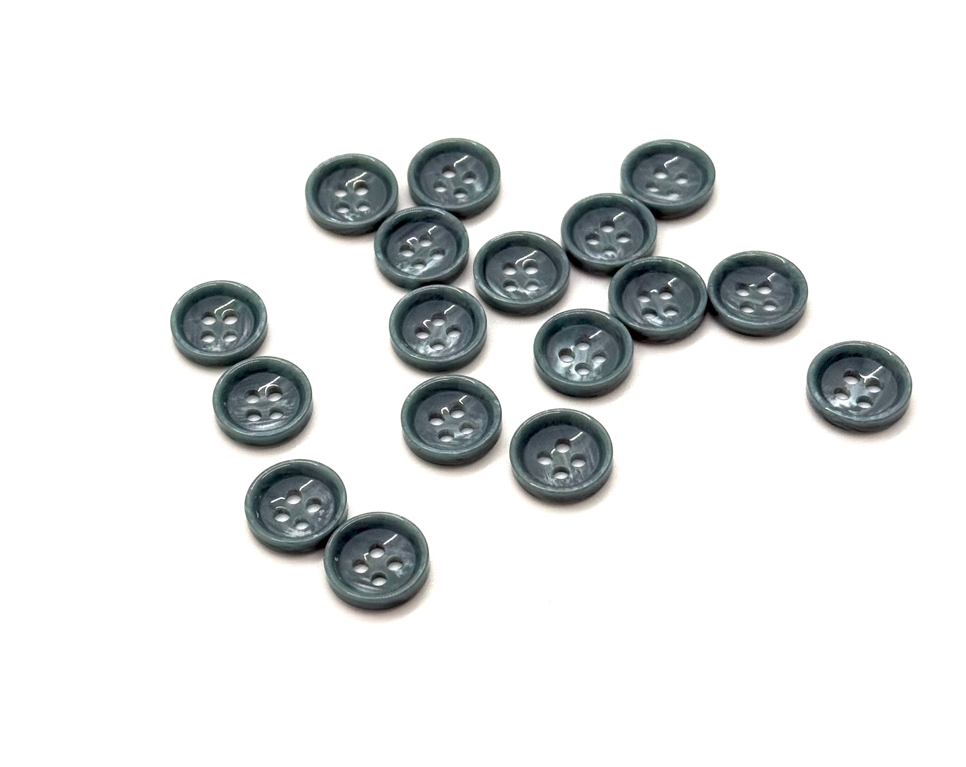 Close-up image of Jade Ridge Dimple 18L Button, a premium quality button.