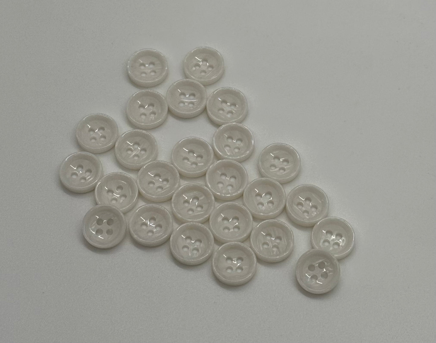 Close-up image of White Marble Crest Dimple Button, a premium quality button.