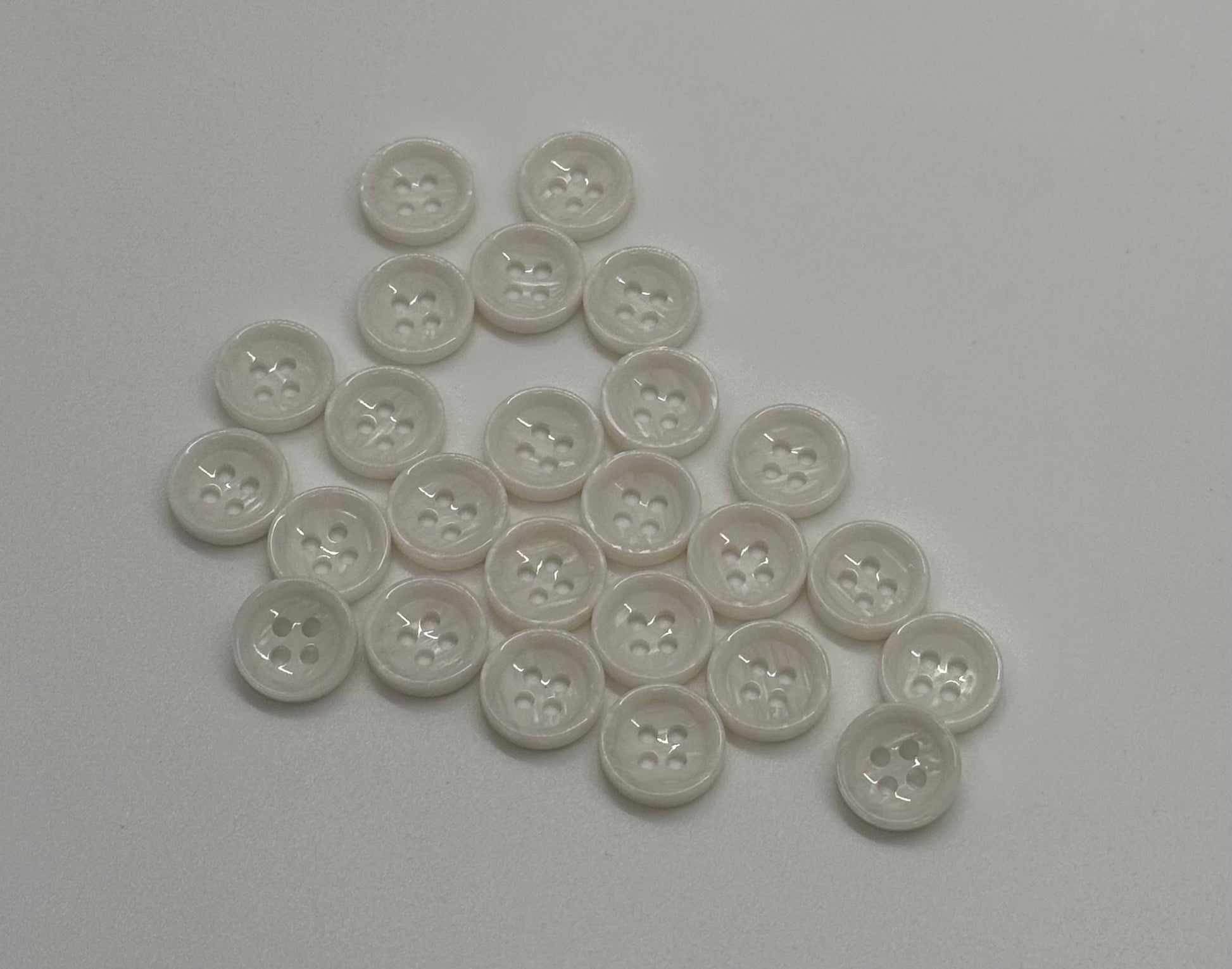 Close-up image of White Marble Crest Dimple Button, a premium quality button.
