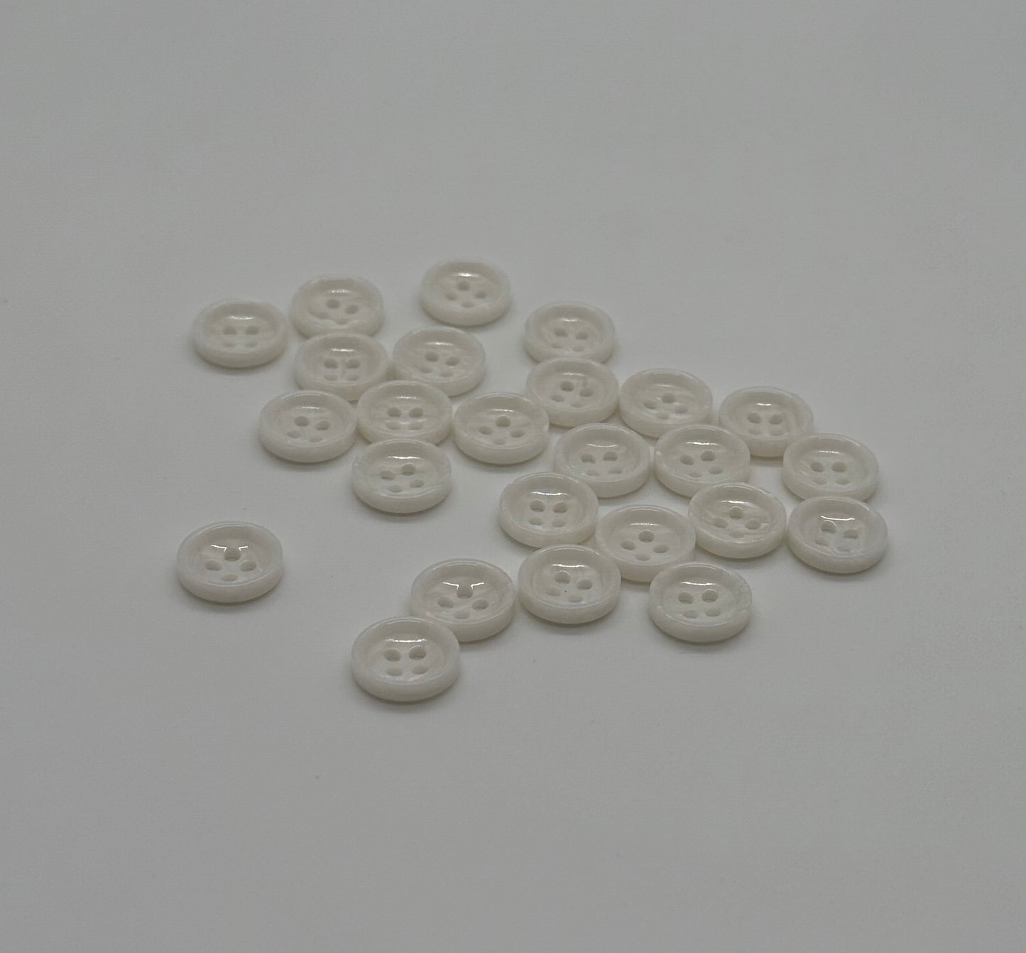 Close-up image of White Marble Crest Dimple Button, a premium quality button.