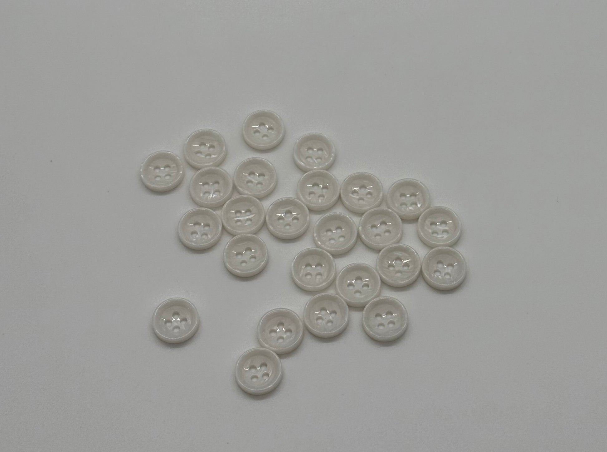 Close-up image of White Marble Crest Dimple Button, a premium quality button.