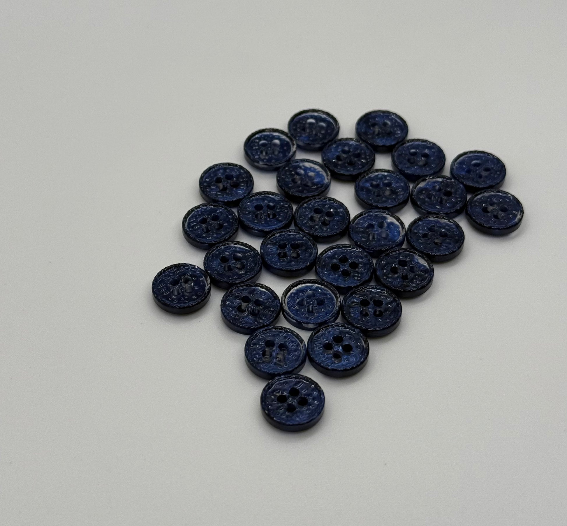 Close-up image of Midnight Spark Fancy 4-Hole Button, a premium quality button.