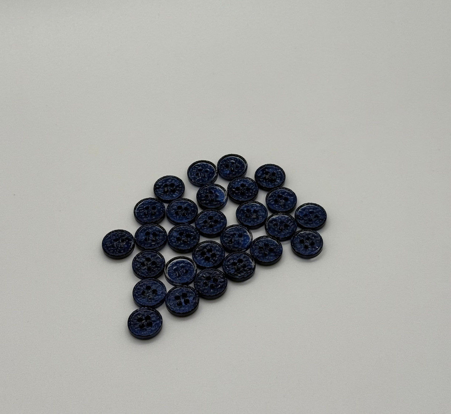 Close-up image of Midnight Spark Fancy 4-Hole Button, a premium quality button.