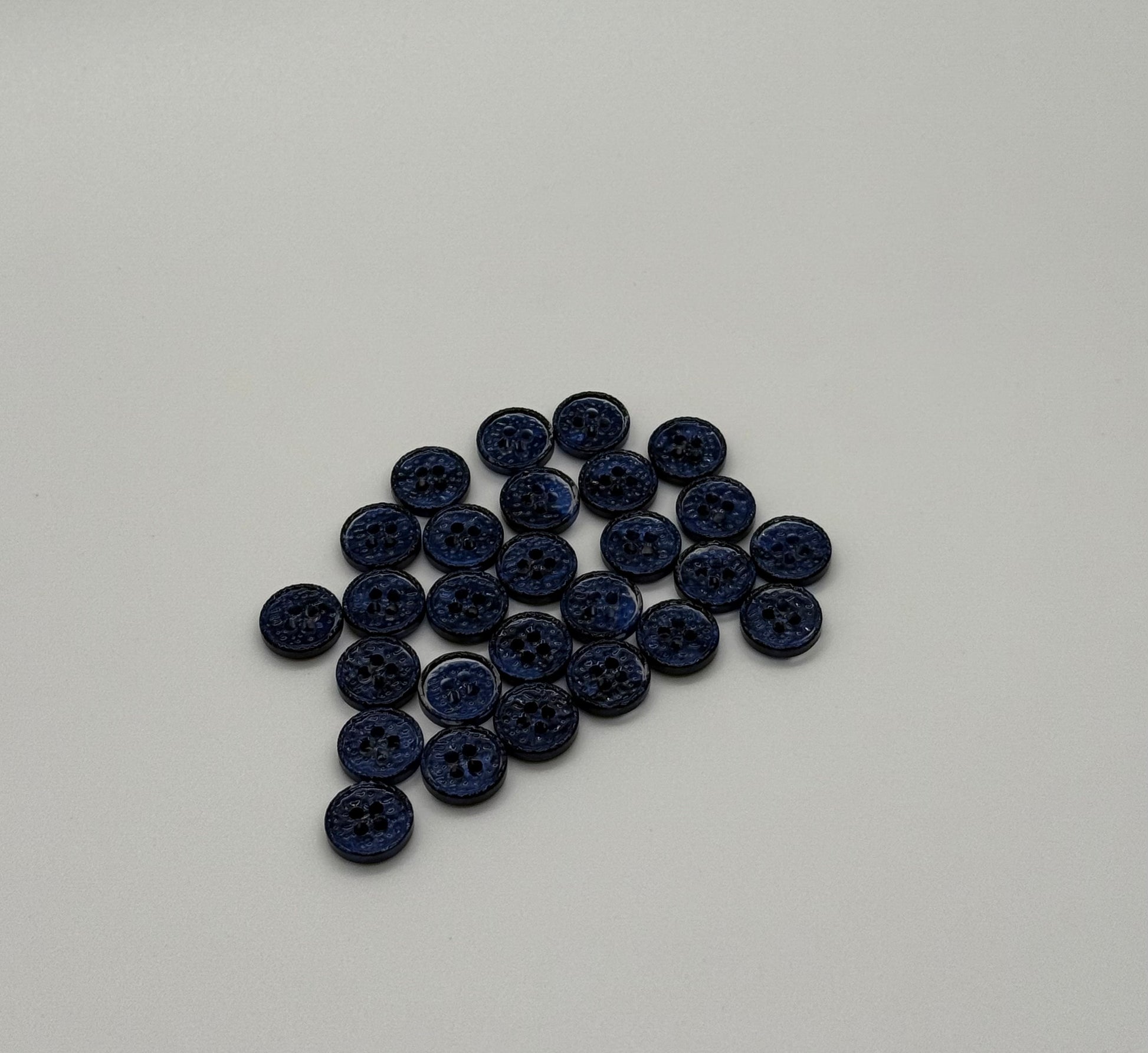 Close-up image of Midnight Spark Fancy 4-Hole Button, a premium quality button.