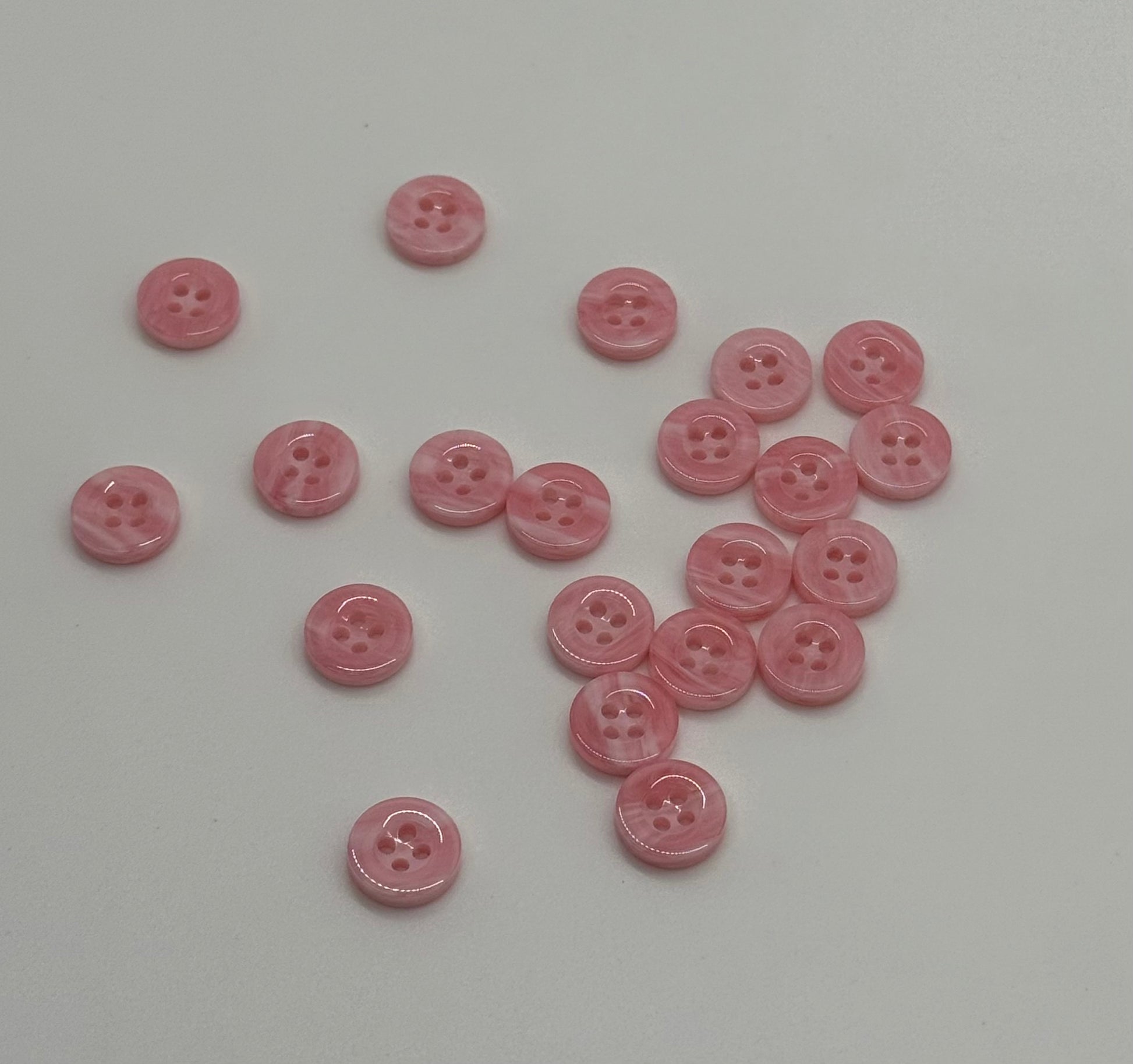 Close-up image of Pink Cloud 4-Hole 18L Button, a premium quality button.