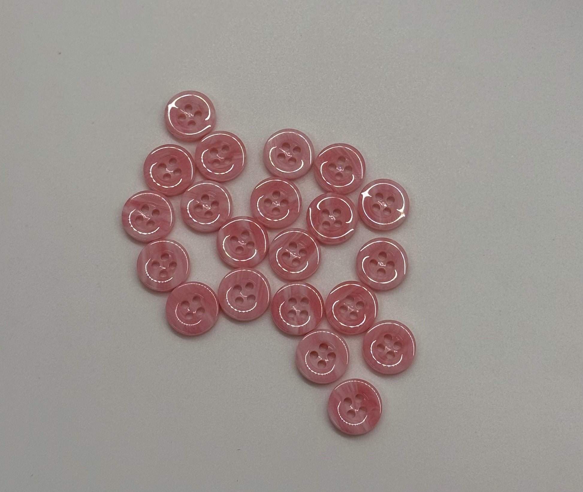 Close-up image of Pink Cloud 4-Hole 18L Button, a premium quality button.