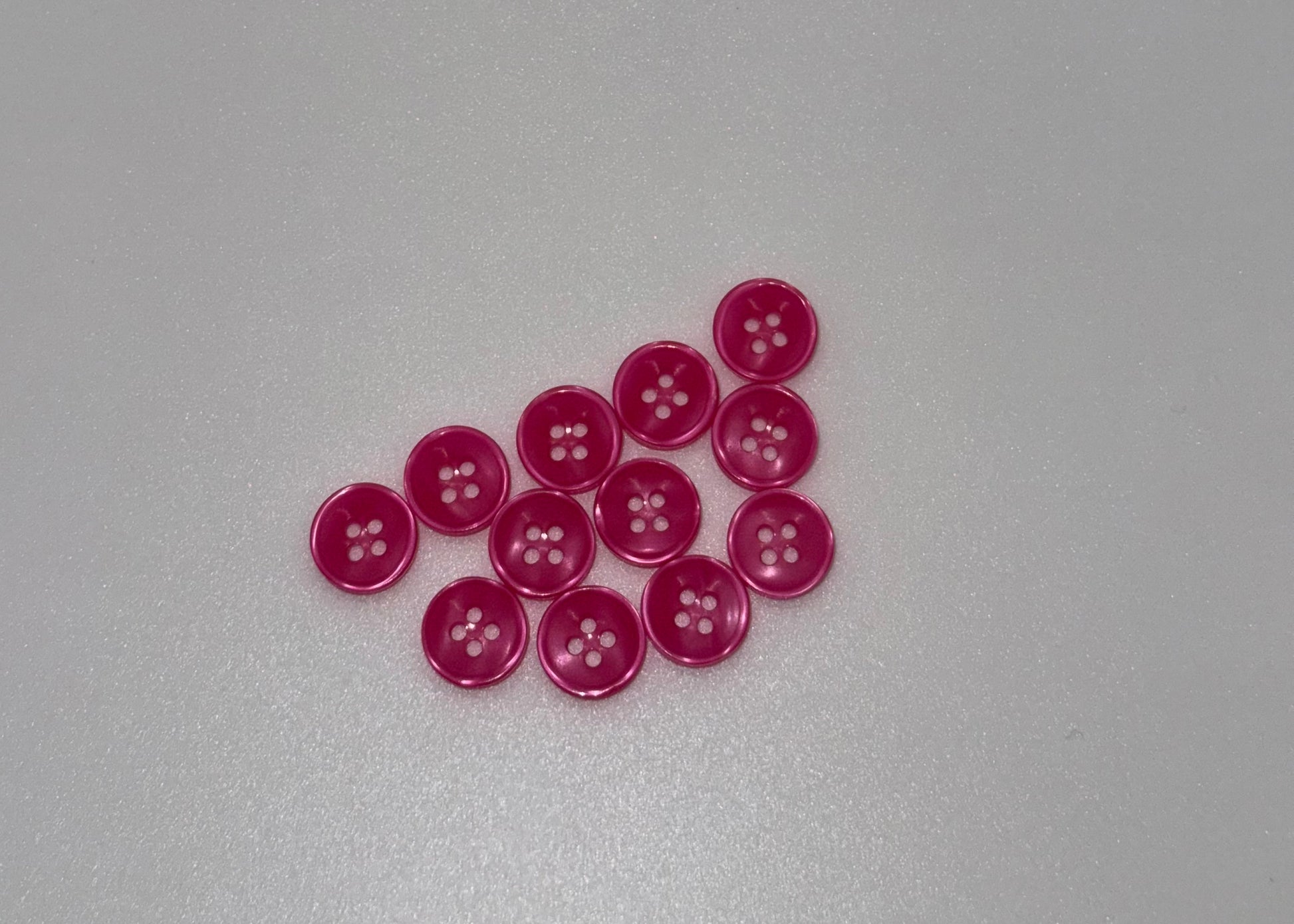 Close-up image of Rose Glow - Pink Iridescent 18-Ligne Button, a premium quality button.