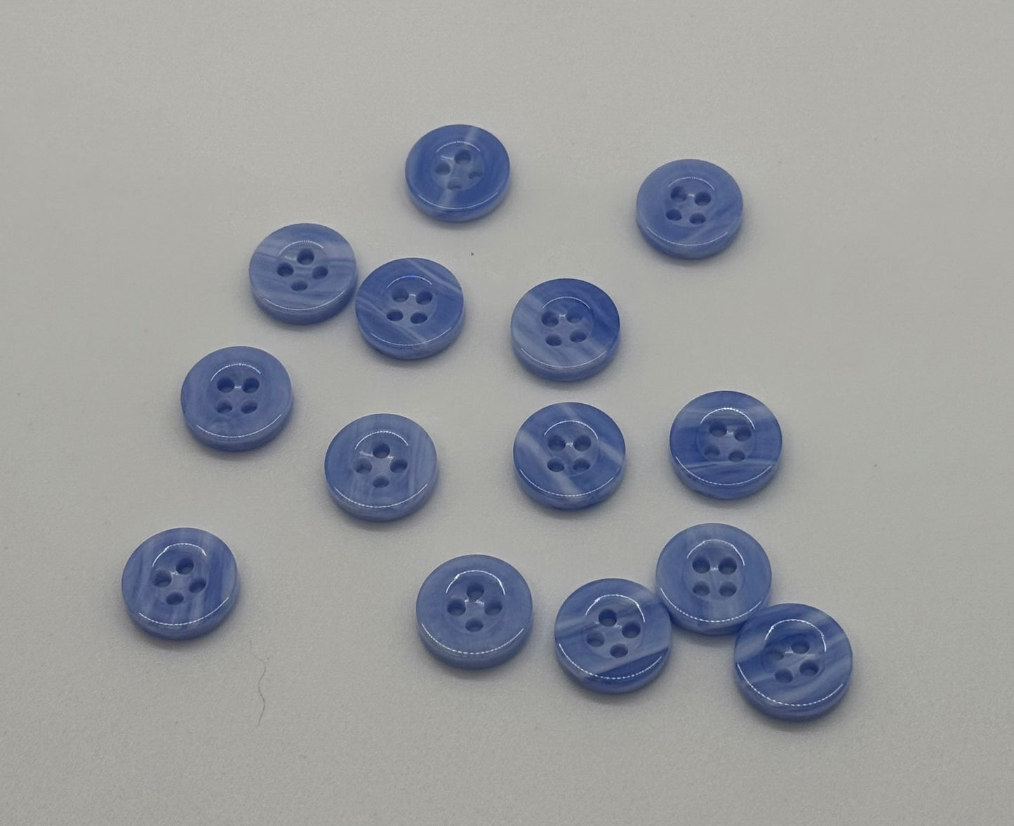 Close-up image of Sky Drift - Cloudy Blue 18L Button, a premium quality button.