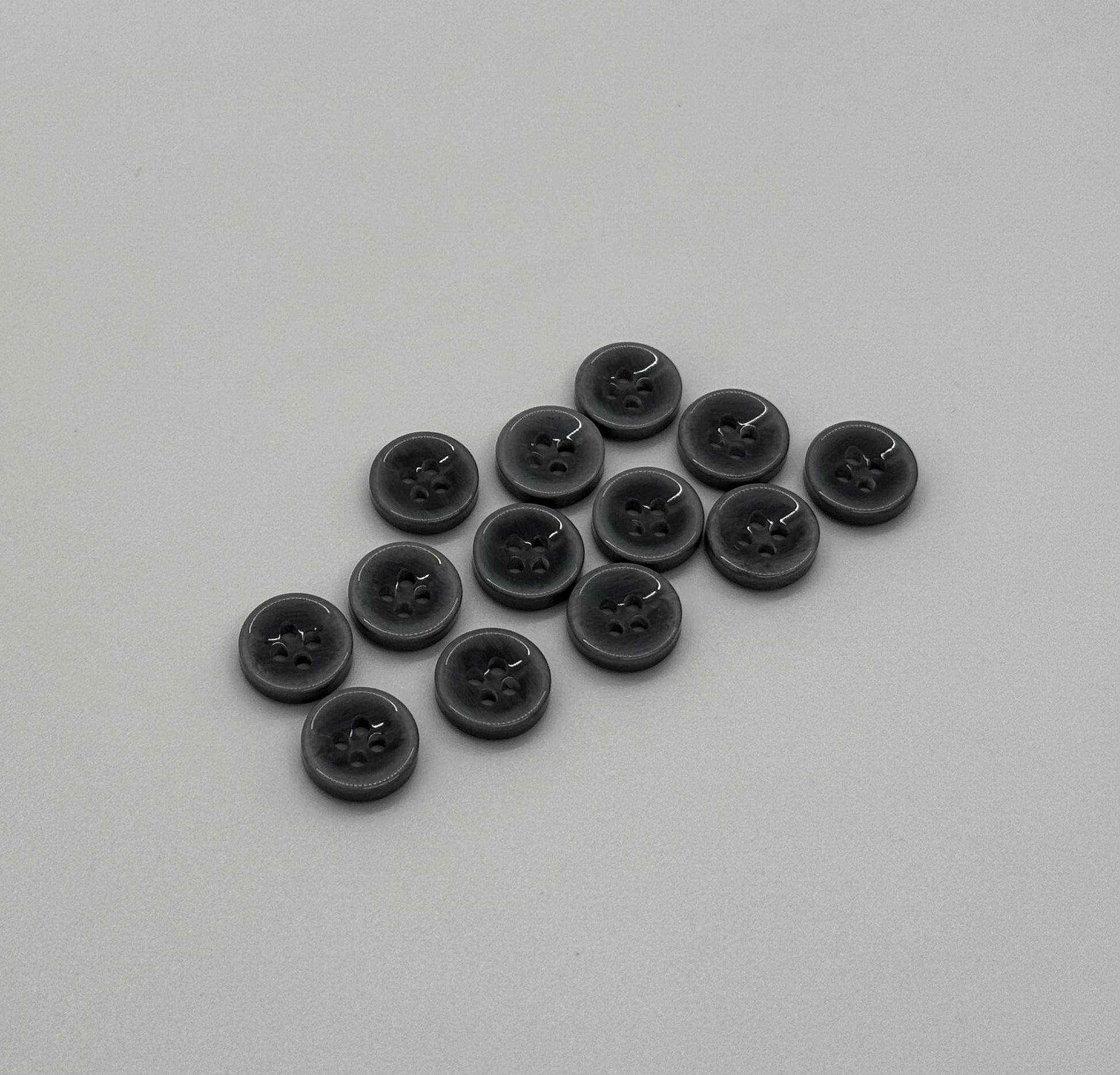 Close-up image of Smokewave - Grey to Smoke 18L Button, a premium quality button.