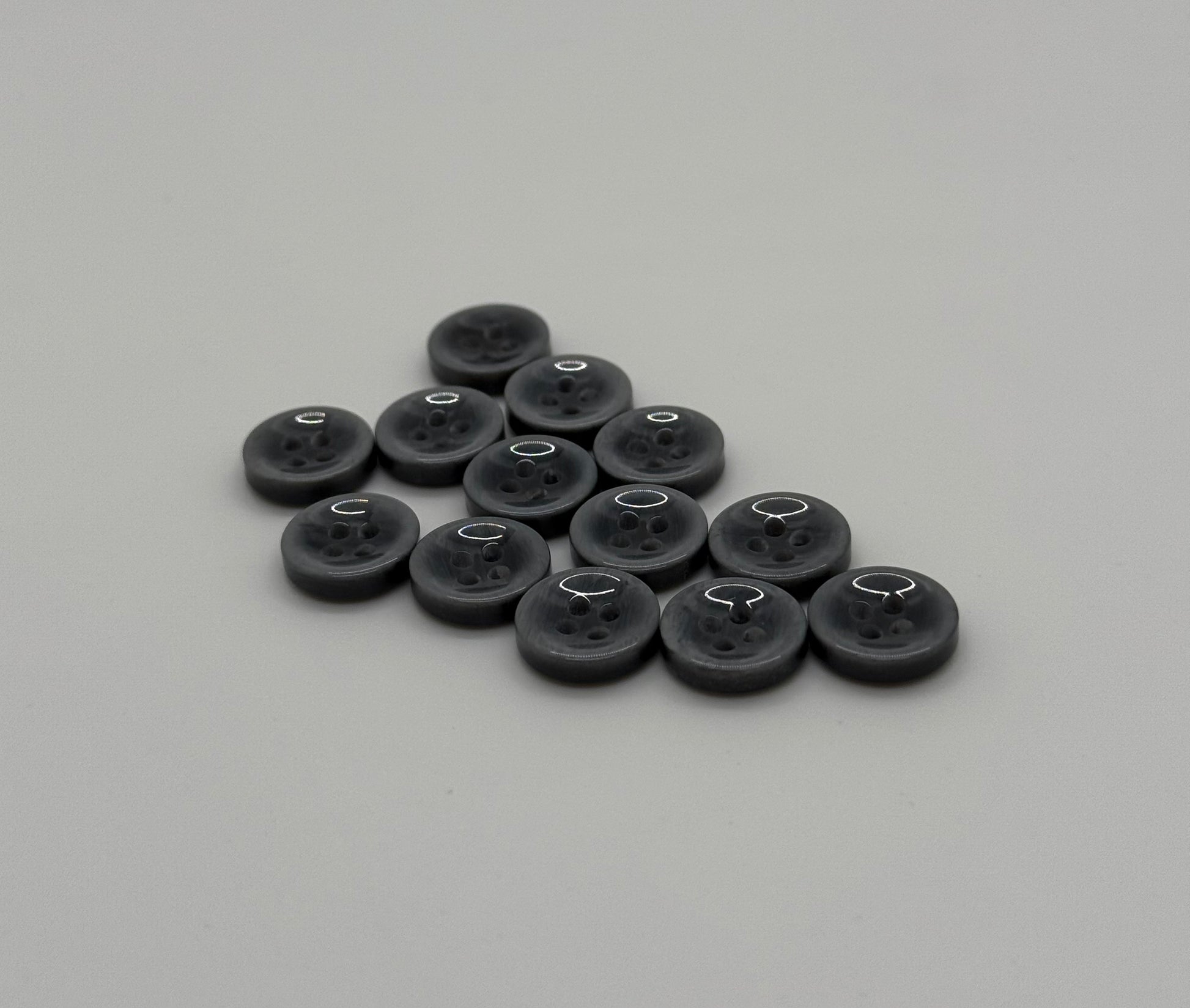 Close-up image of Smokewave - Grey to Smoke 18L Button, a premium quality button.