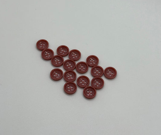 Close-up image of Terra Blush - Pale Red Dimble Button, a premium quality button.