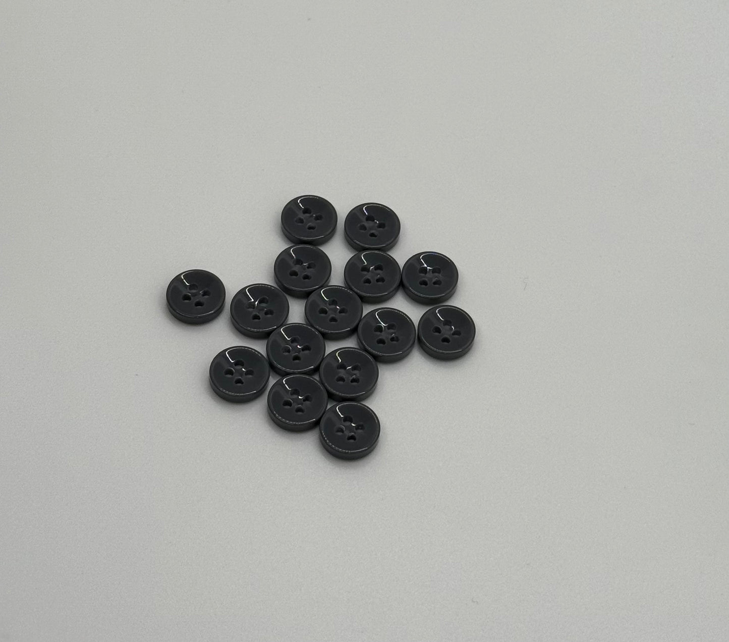 Close-up image of Urban Steel 4-Hole 18L Button, a premium quality button.