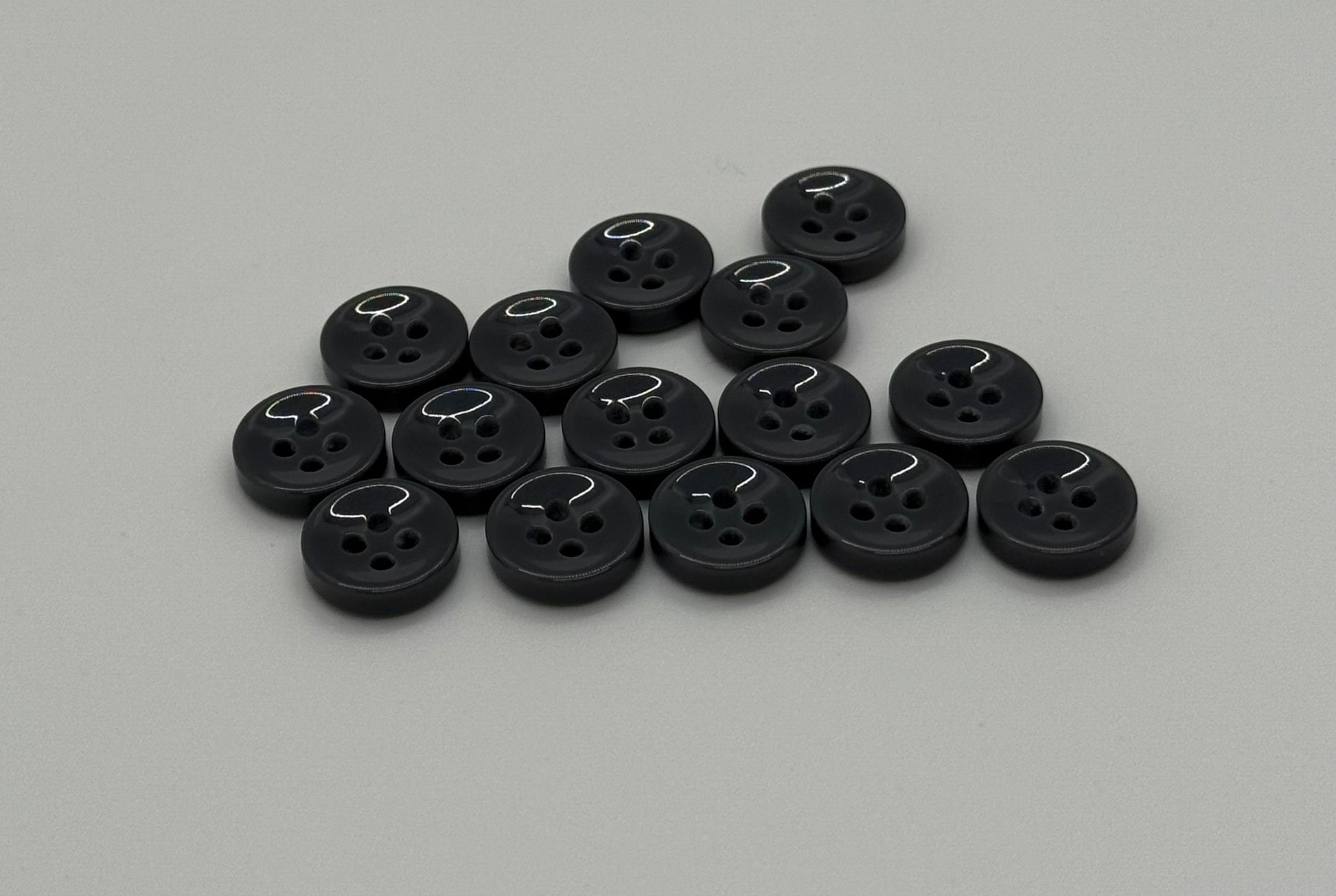 Close-up image of Urban Steel 4-Hole 18L Button, a premium quality button.