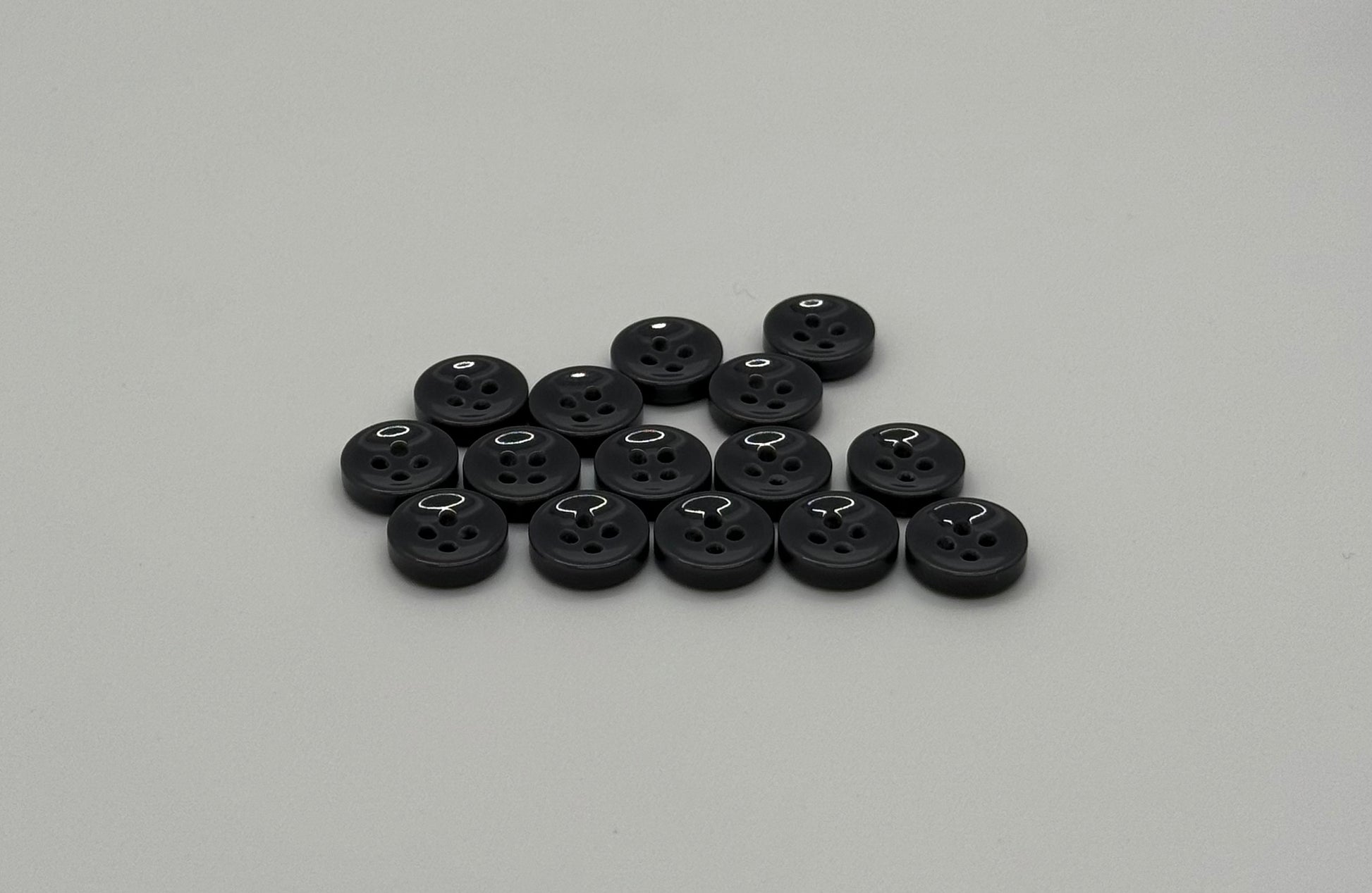 Close-up image of Urban Steel 4-Hole 18L Button, a premium quality button.