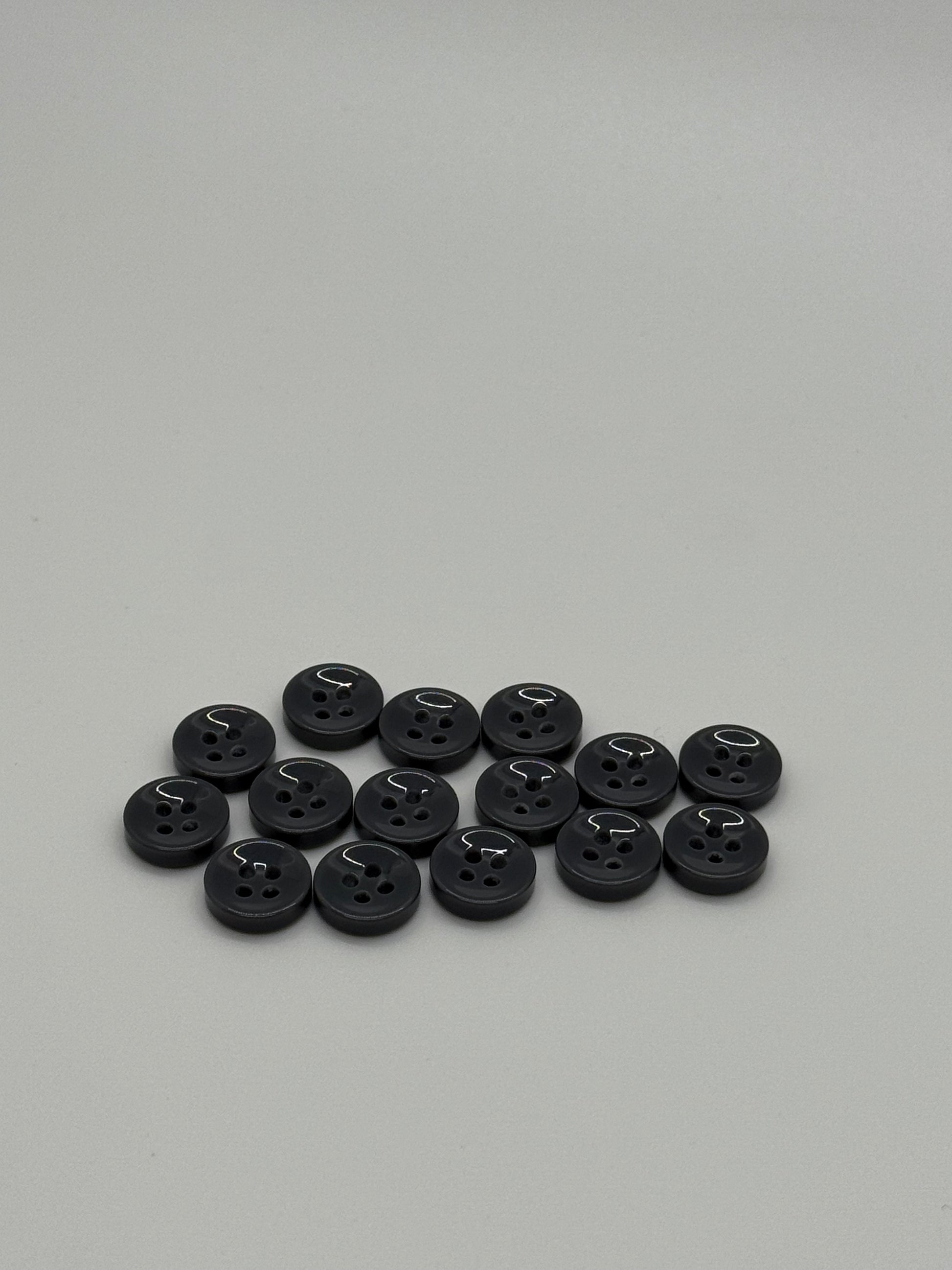 Close-up image of Urban Steel 4-Hole 18L Button, a premium quality button.