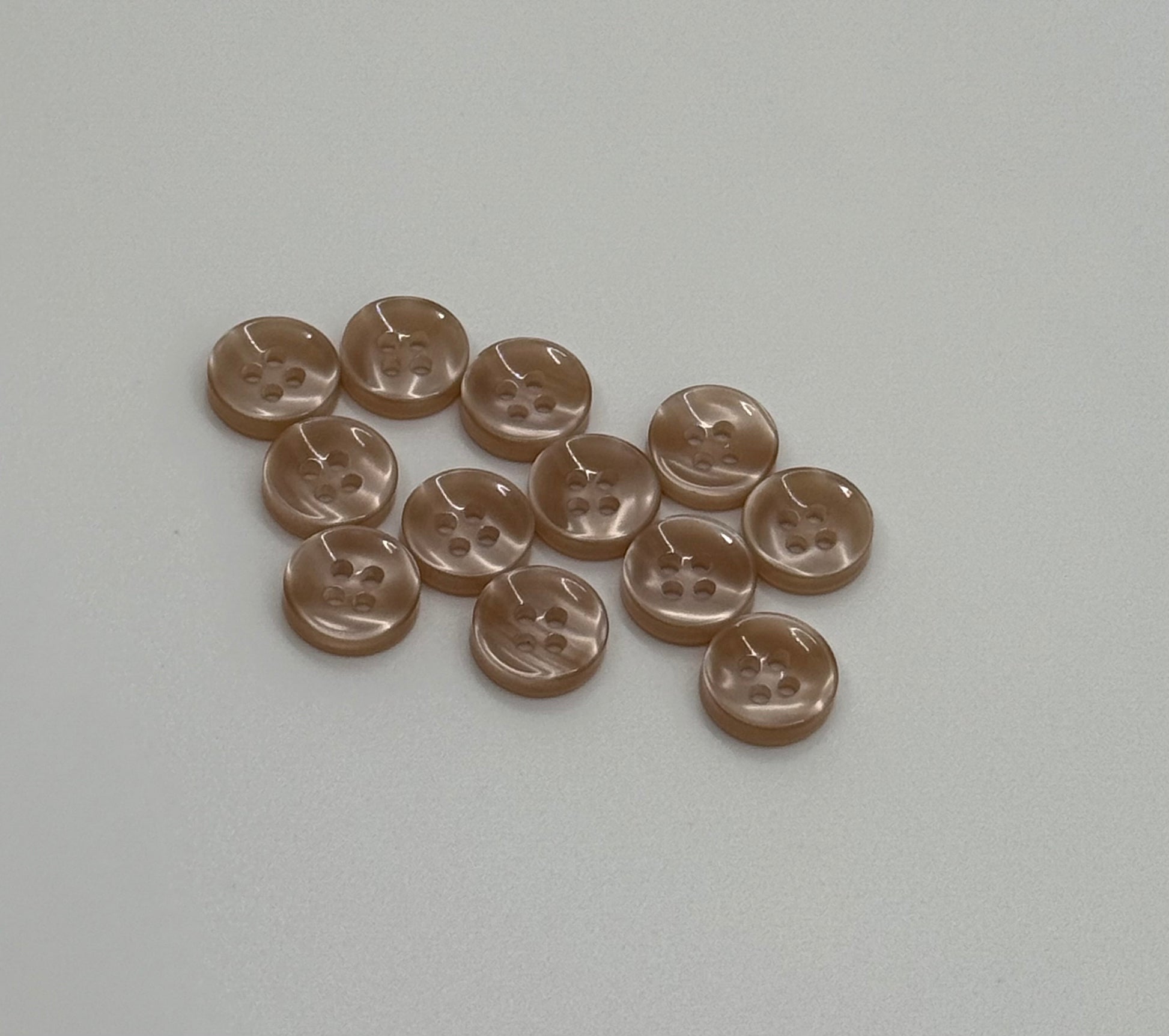 Close-up image of Warm Sand - Light Brown Iridescent 18-Ligne Button, a premium quality button.