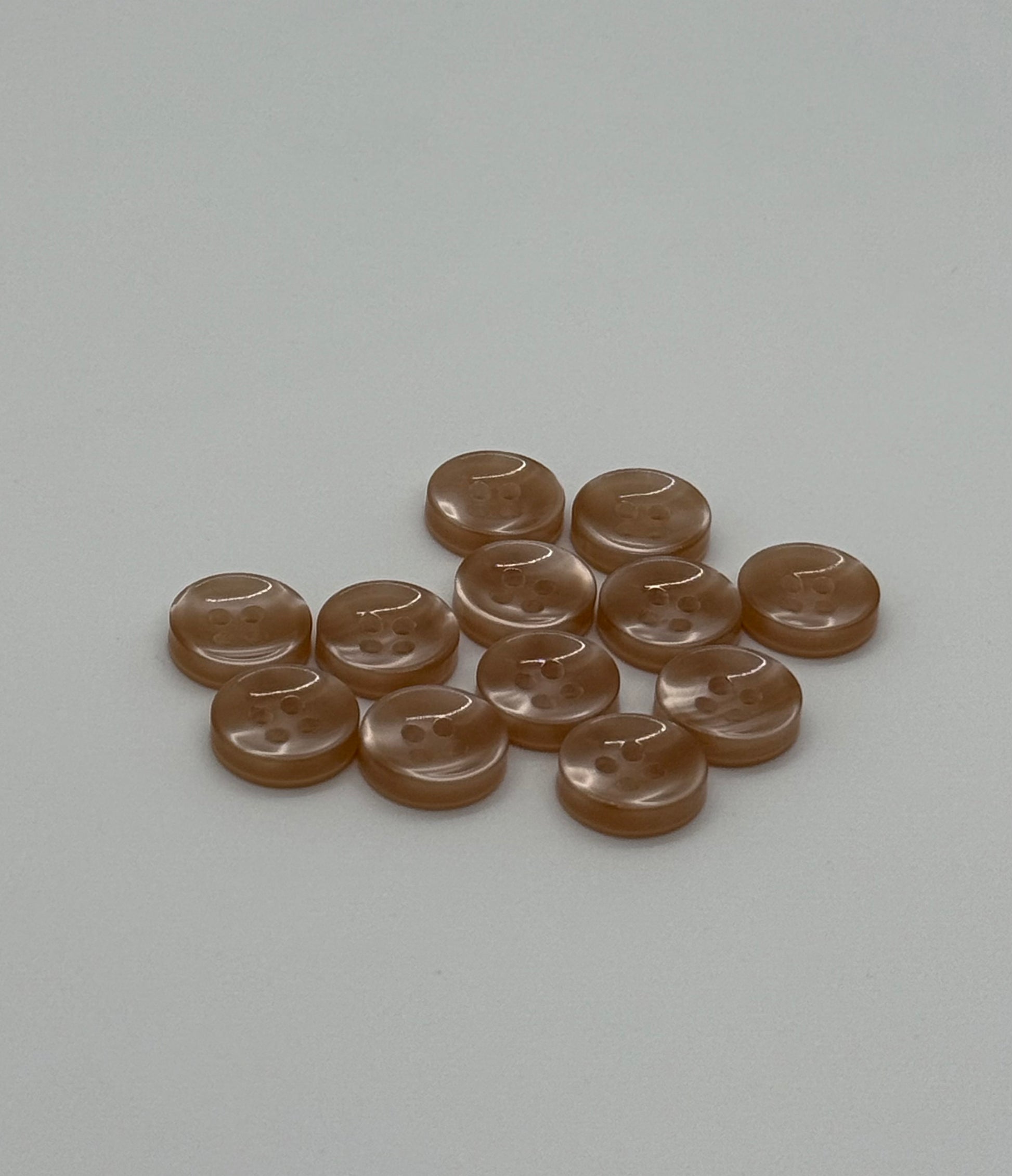 Close-up image of Warm Sand - Light Brown Iridescent 18-Ligne Button, a premium quality button.